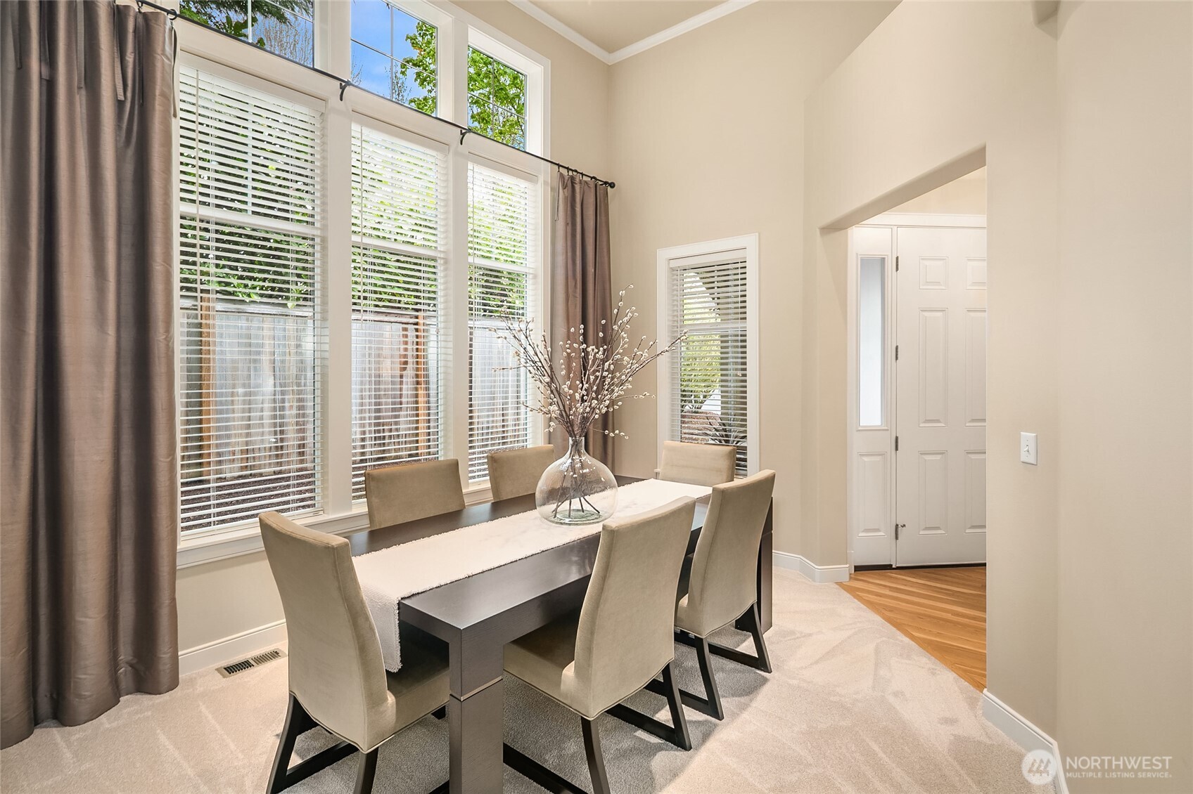 Soaring 14-foot-high ceilings with expansive windows bring in plenty of light for the formal dining room which makes perfect for entertaining.