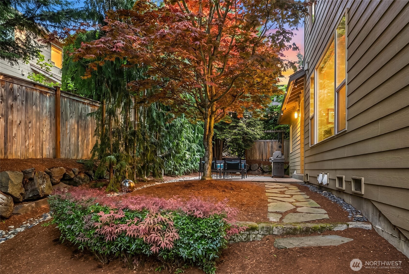 Peaceful and tranquil backyard setting offers privacy and space to relax or entertain.