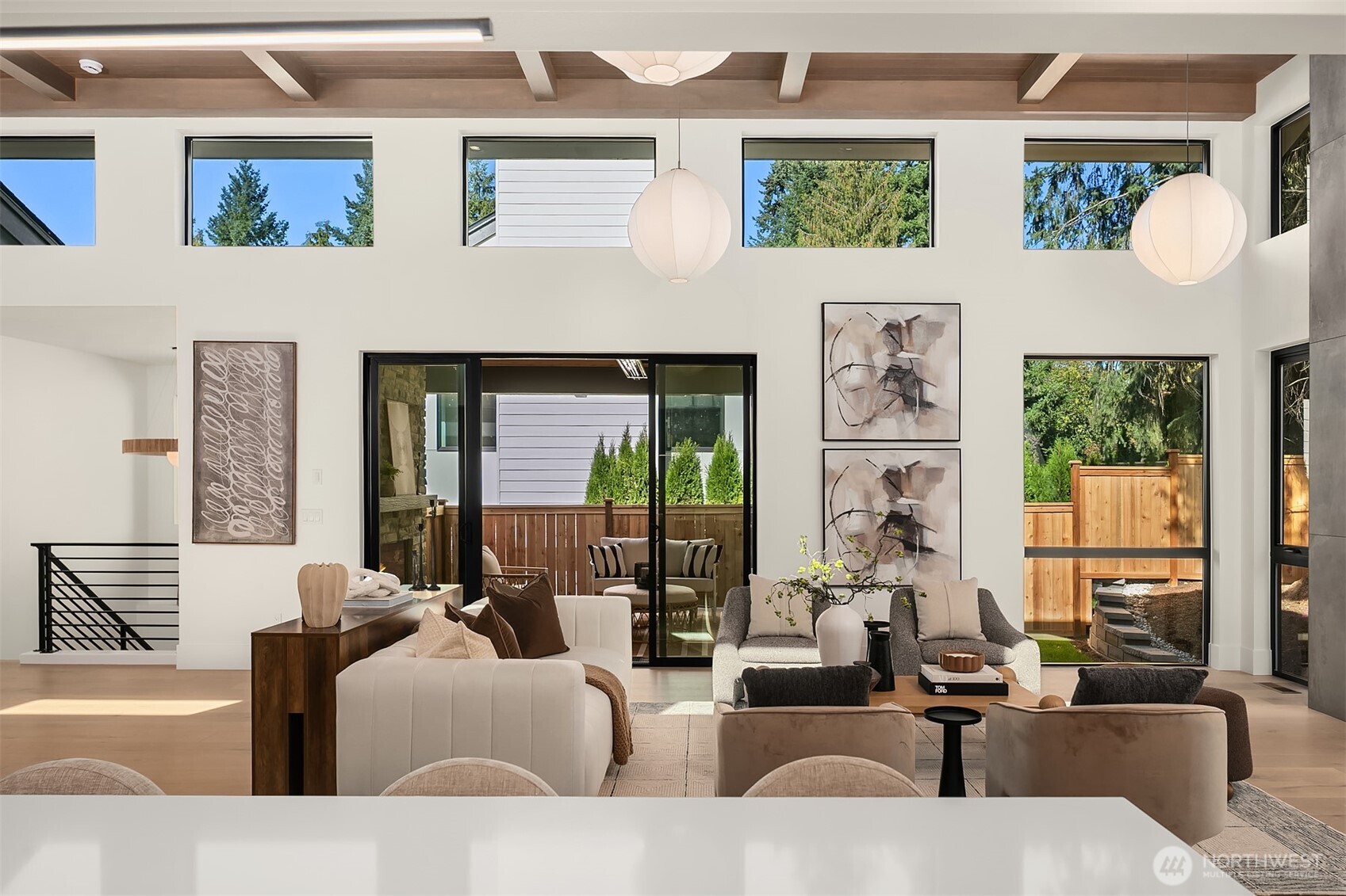 Covered patio designed for year-round enjoyment with floor-to-ceiling stone gas fireplace, infrared heater, and built-in speakers.