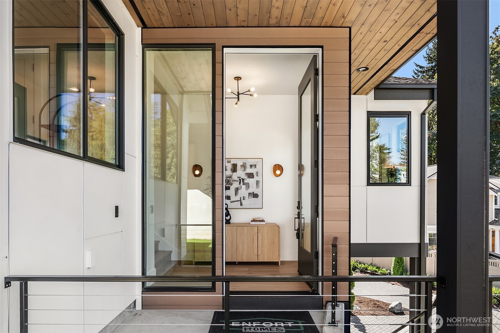 A dramatic 10-foot entry door welcomes you into the home, setting the stage for grand, yet warm, modern living.