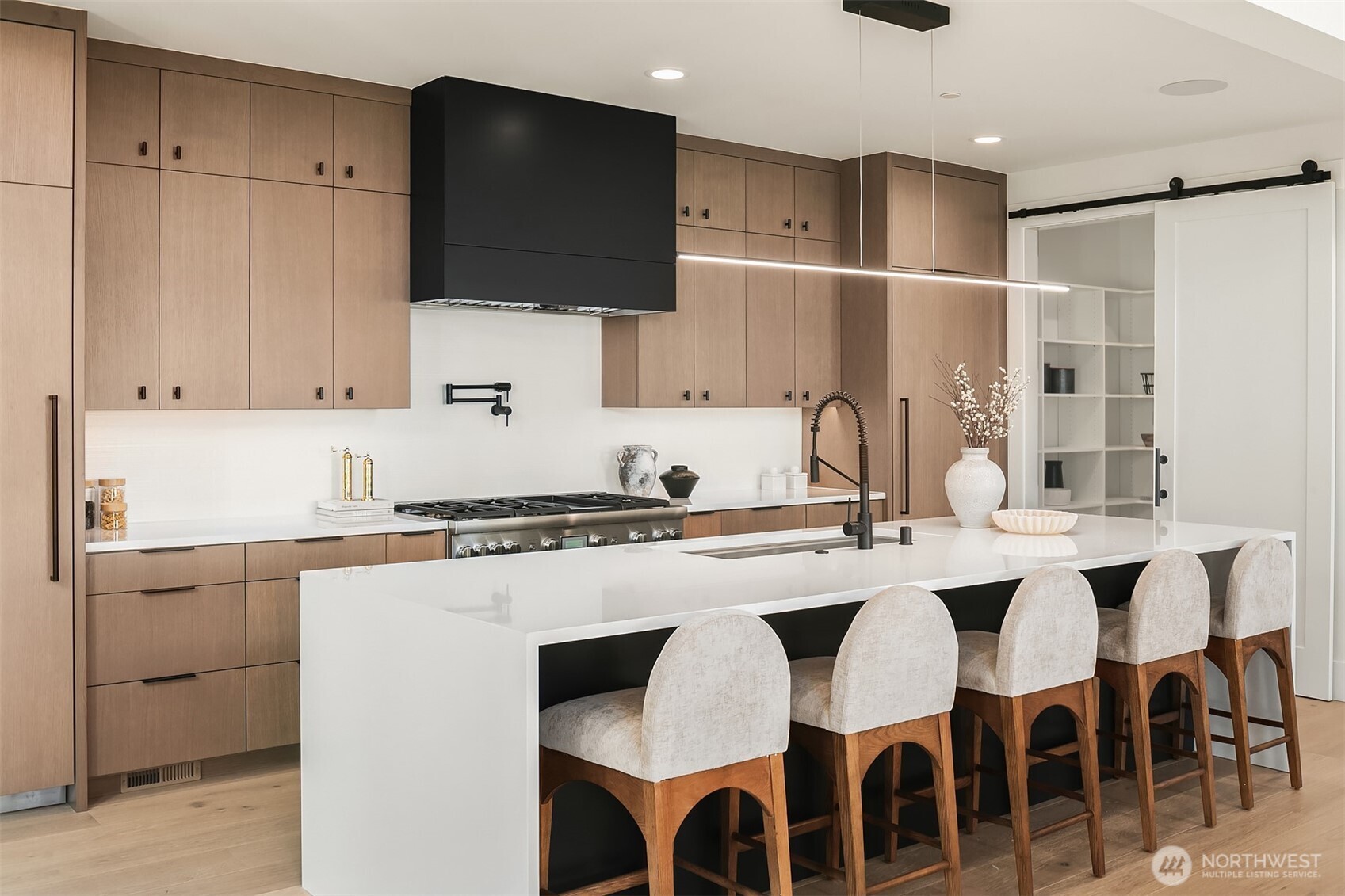 Full suite of professional Thermador appliances, 72" paneled refrigeration, dedicated pot filler, and walk-in pantry with room for a second refrigerator.