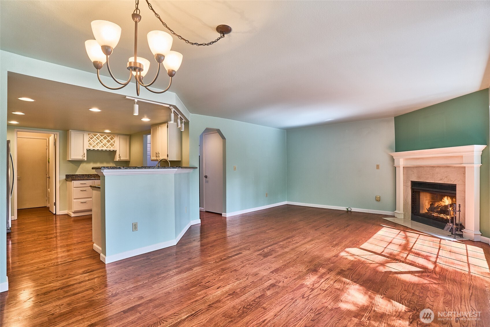 Another view of the living room shows the convenience of the open kitchen next to it.