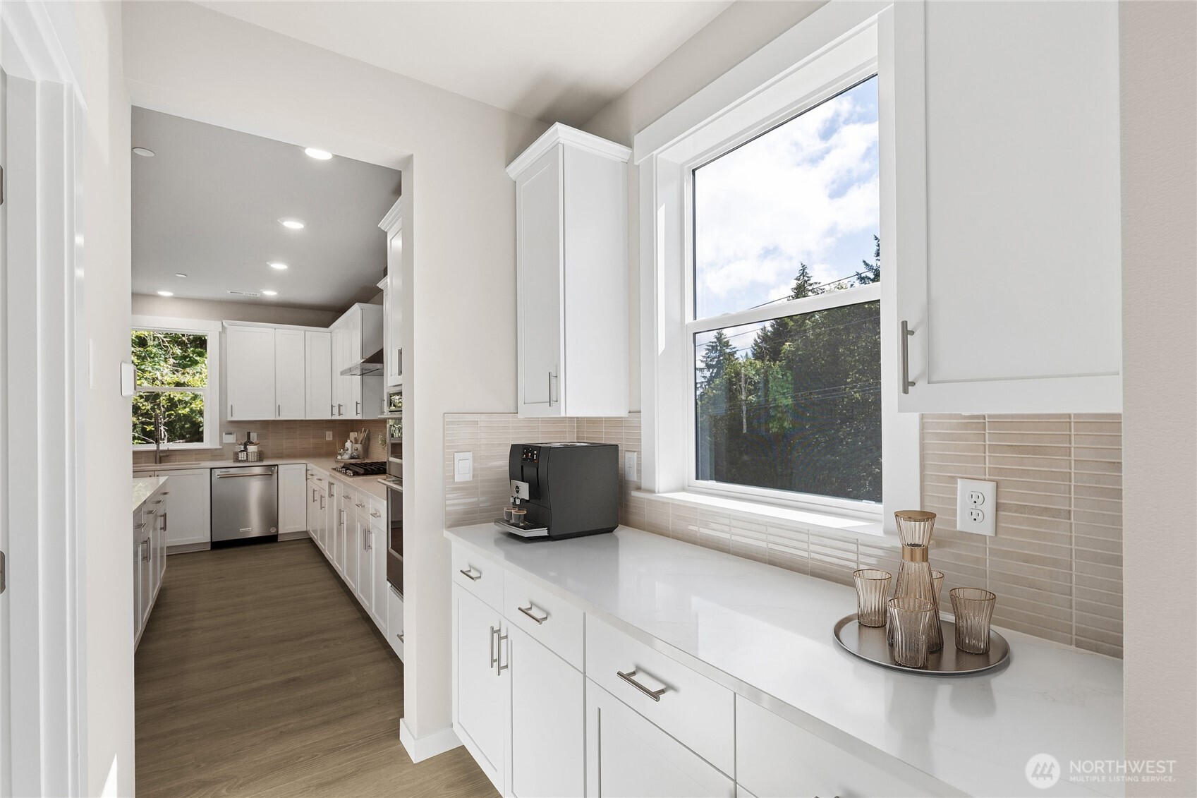 From formal dining, butlers pantry leading into the kitchen, pantry includes built in shelving. Virtually staged.