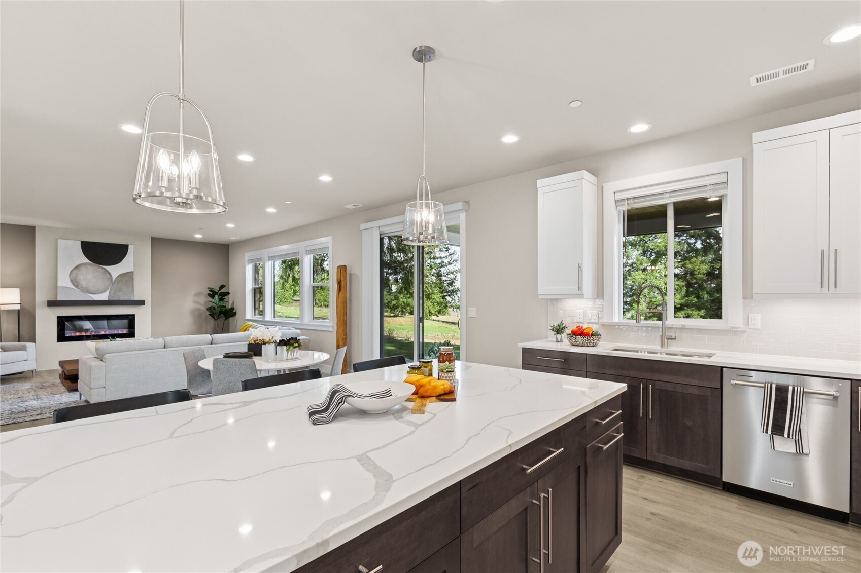 Same home from another community showing kitchen overlooking informal dining + great room.  This photo has upgrades, home for sale will have all white cabinetry throughout.