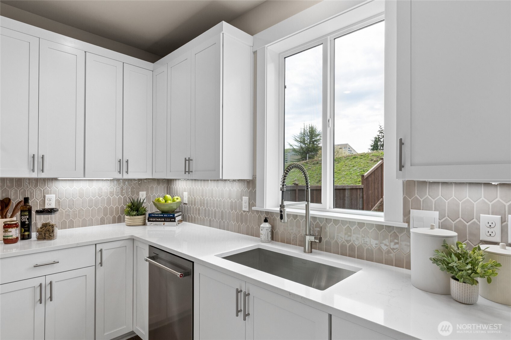 Quartz slab countertops with full height backsplash.  Savannah Model Home showing accurate cabinet color, lighting package and included appliances.