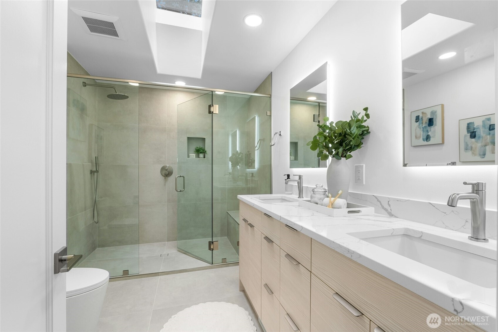 New primary bath with new cabinets, dual sinks, quartz counters and large curb-less designer shower.