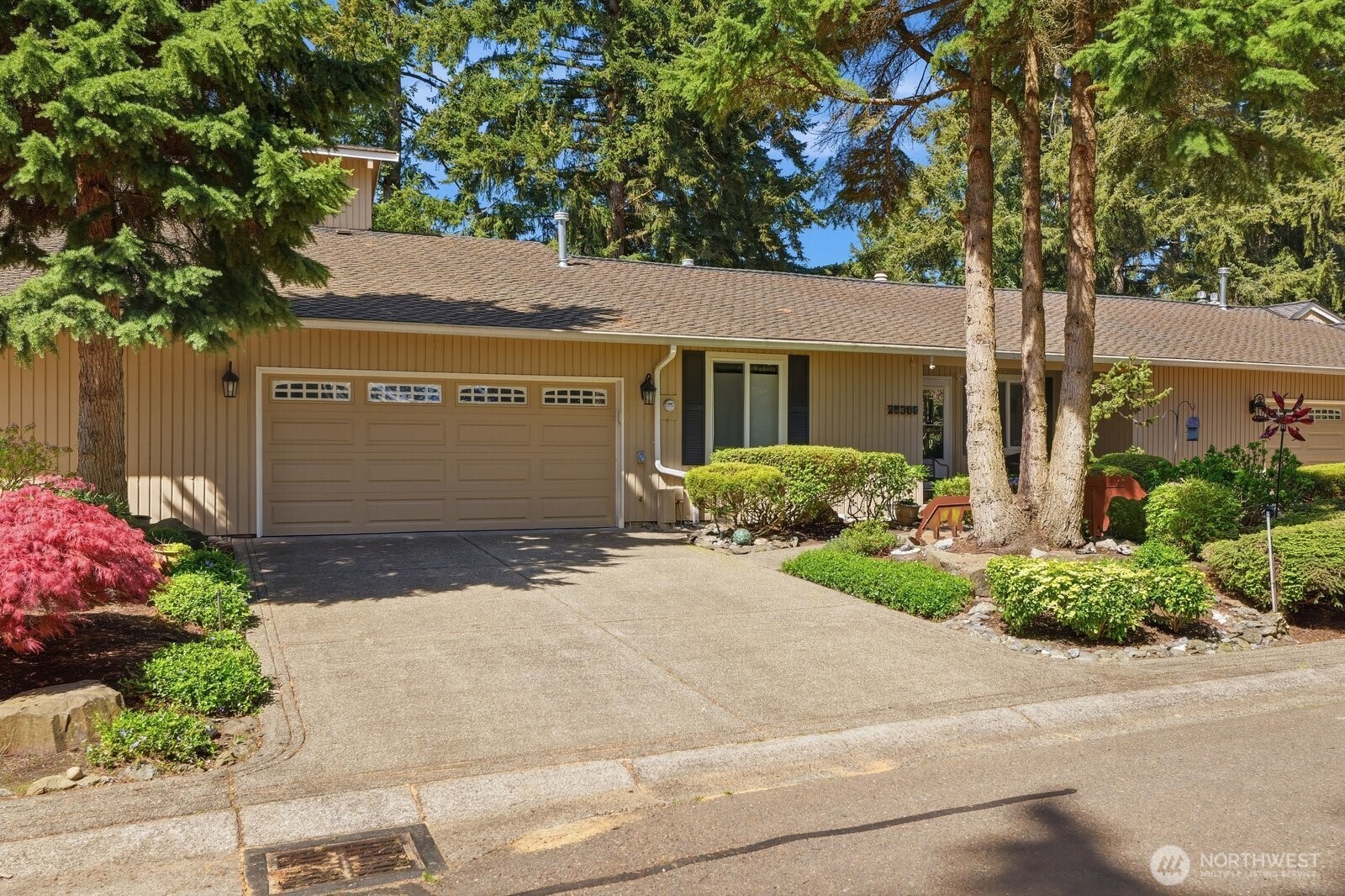 Impeccably maintained exterior with manicured landscaping and a private, inviting entrance.