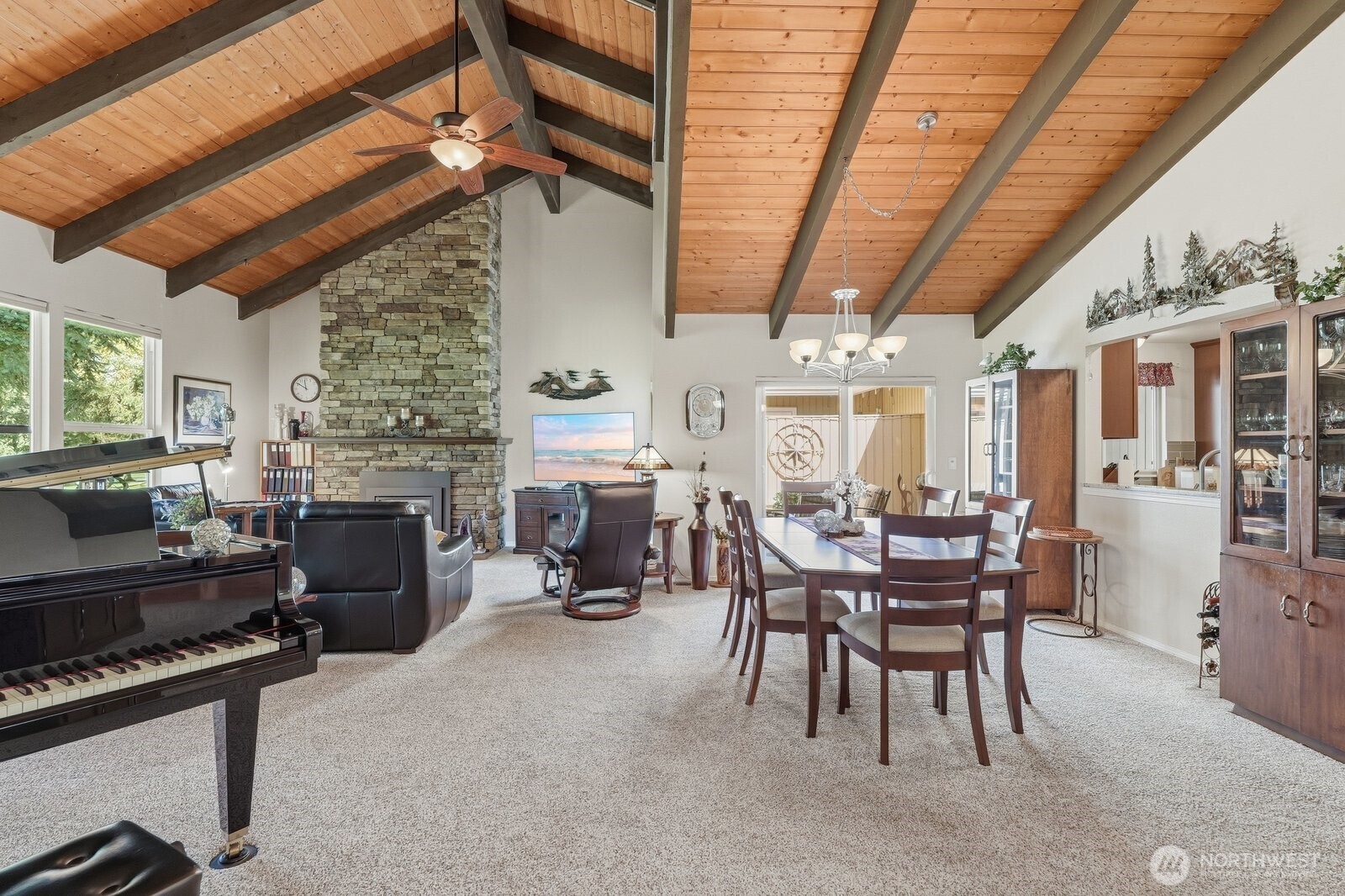 Soaring vaulted wood ceilings and exposed beams define the expansive living area.