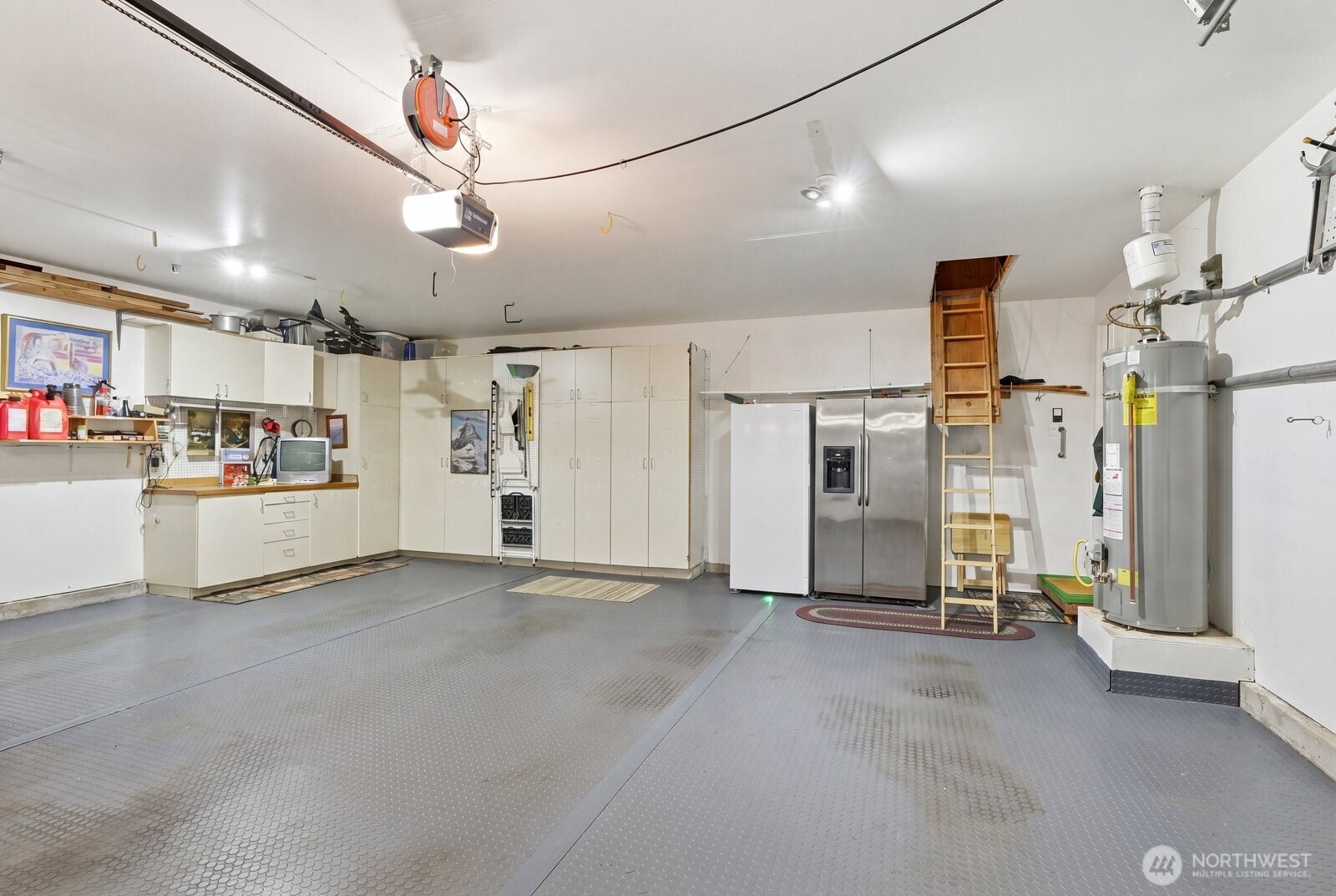 The oversized two-car garage provides plenty of room for vehicles and a workshop area.