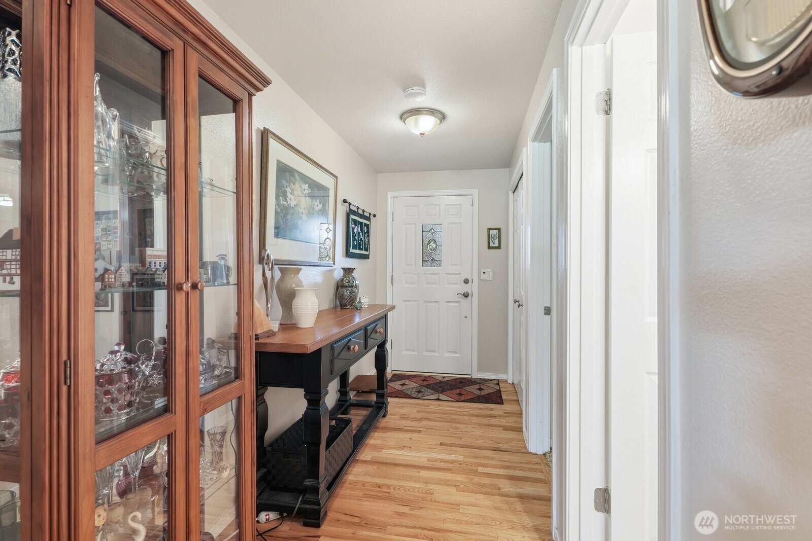 The wide entry hallway highlights the home’s open feel and high-end finishes from the moment you step inside.