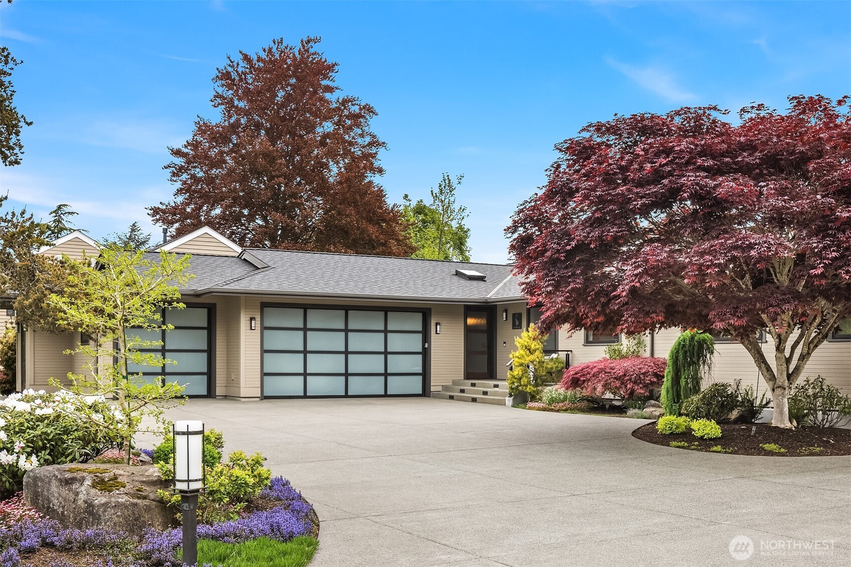 Set back with presence, the approach feels both welcoming and established—mature landscaping, clean architectural lines, and a sense of arrival that holds from the very first glance.