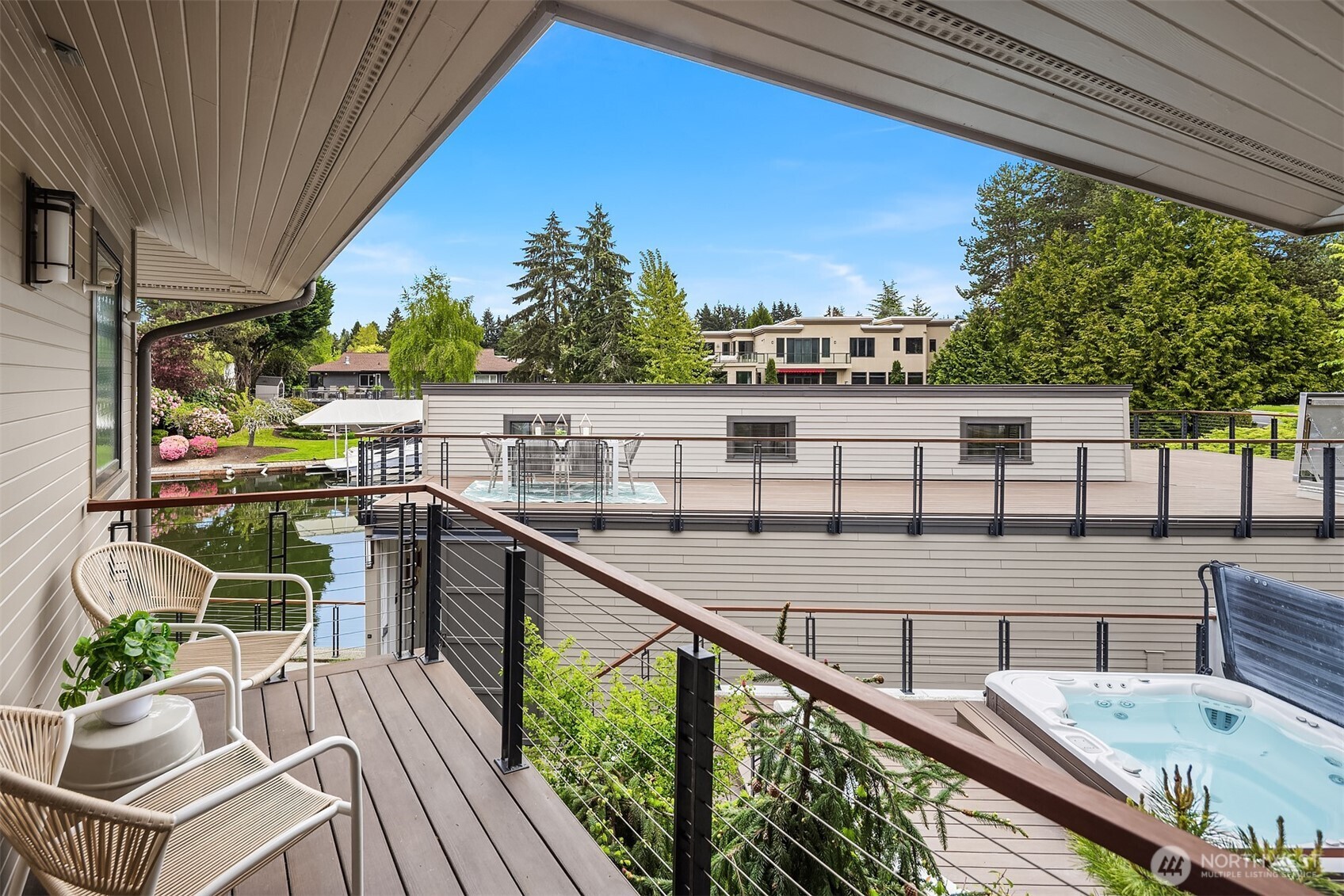 An intimate perch within a larger outdoor composition—overlooking the rooftop deck and canal, where each level offers its own moment.