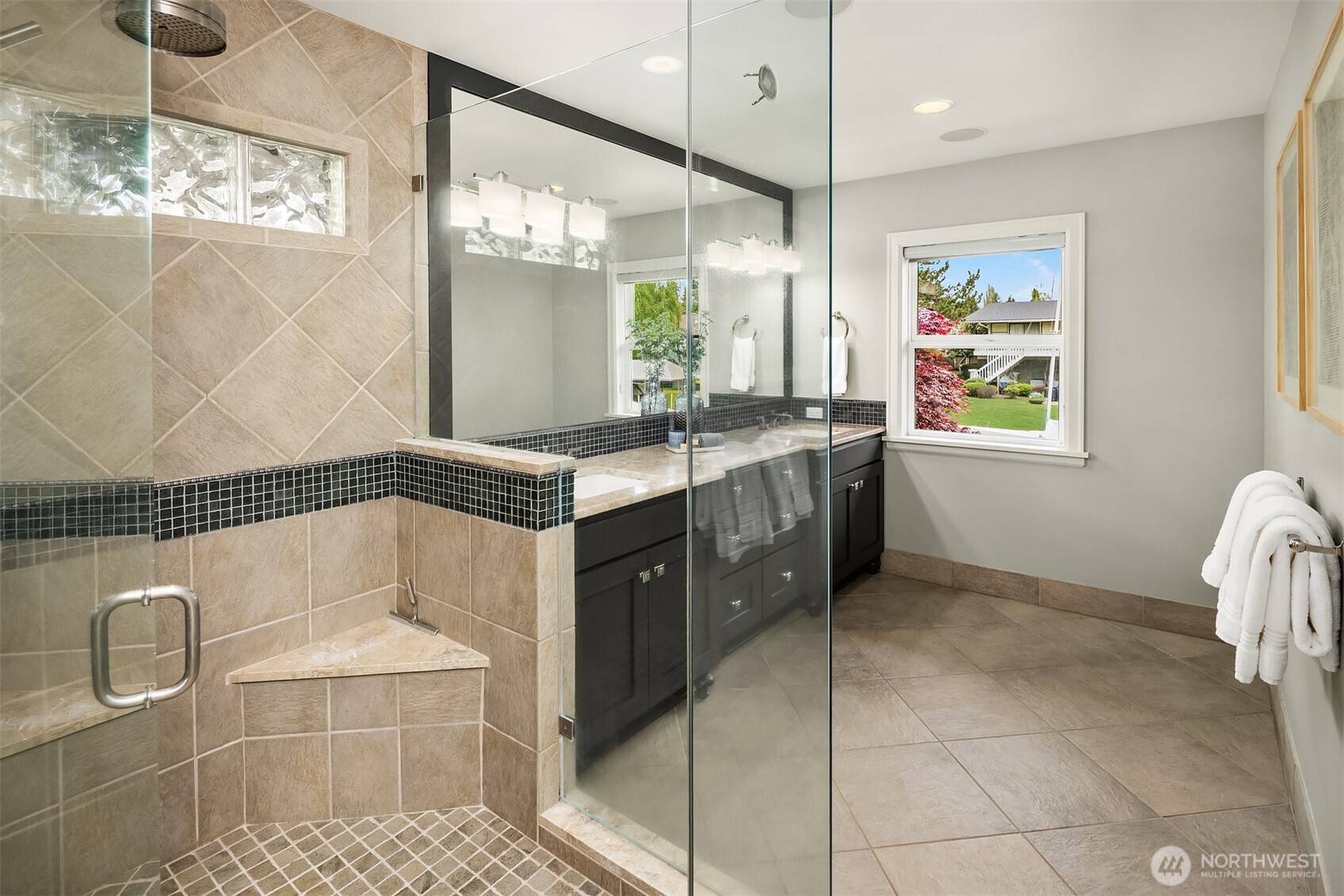 A spacious, spa-inspired bath anchored by a large walk-in shower—designed for both daily ease and a more relaxed, restorative pace.