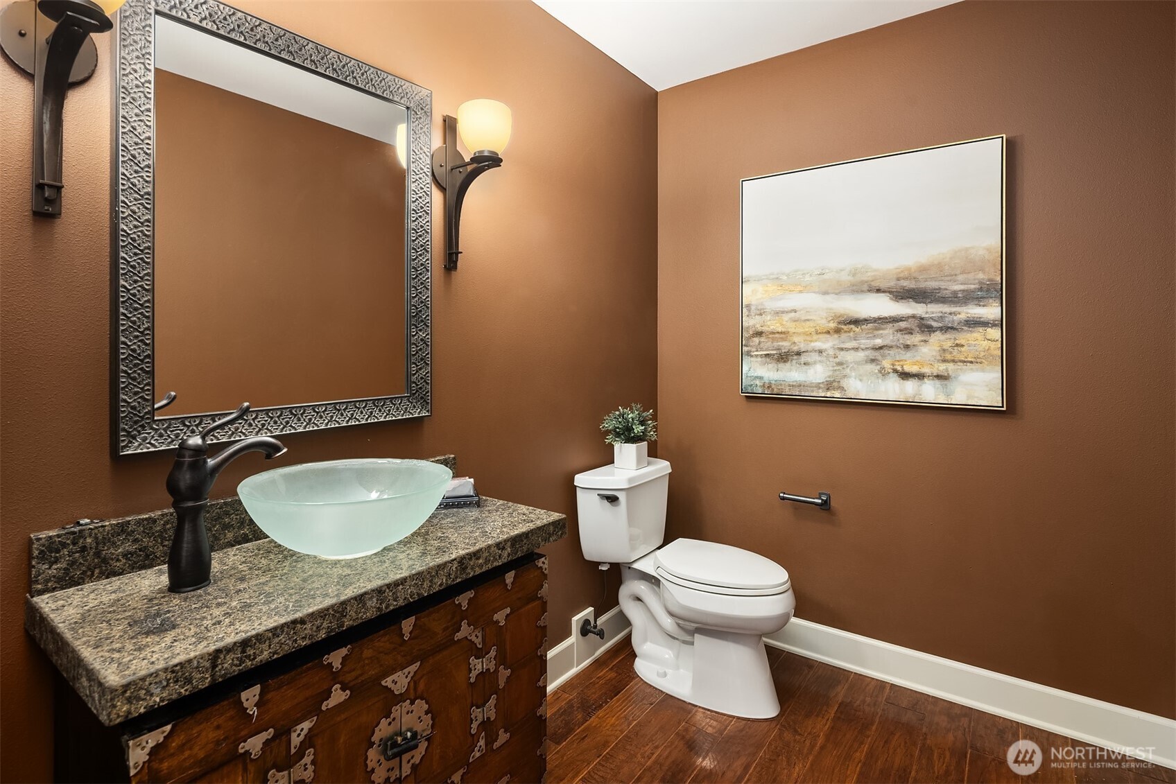 A striking powder room with custom vanity and sculptural vessel sink—an intentional moment of design just off the entry.