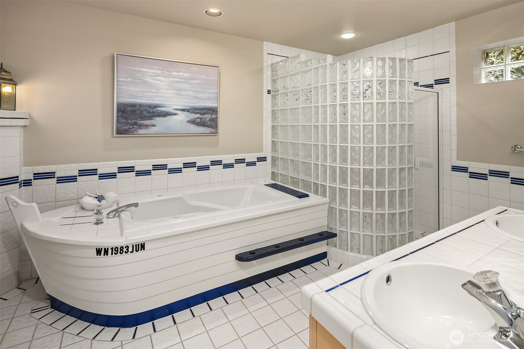 A playful, nautically inspired hall bath—thoughtfully designed with custom details that subtly echo the home’s waterfront setting.