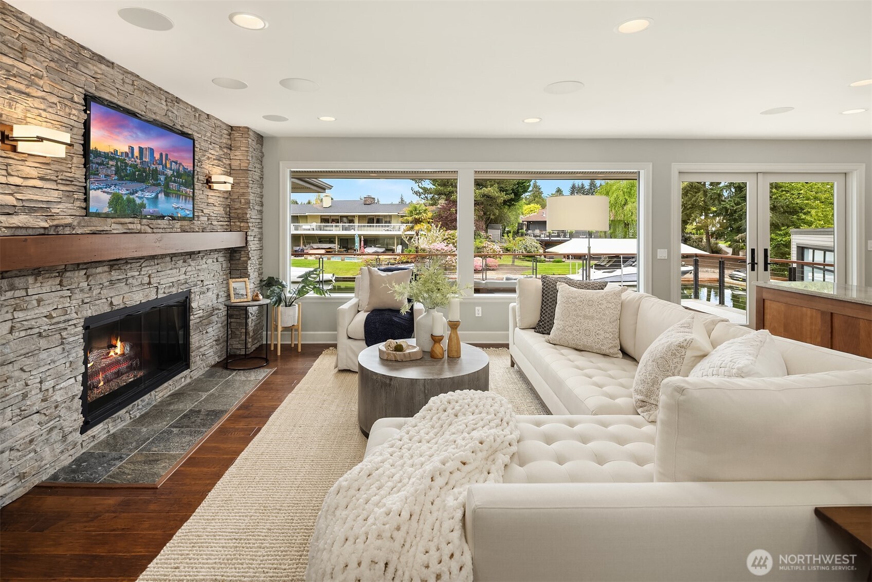 Evenings settle in around the fire as boats drift quietly past—this is where the day slows down and the waterfront becomes part of the room.
