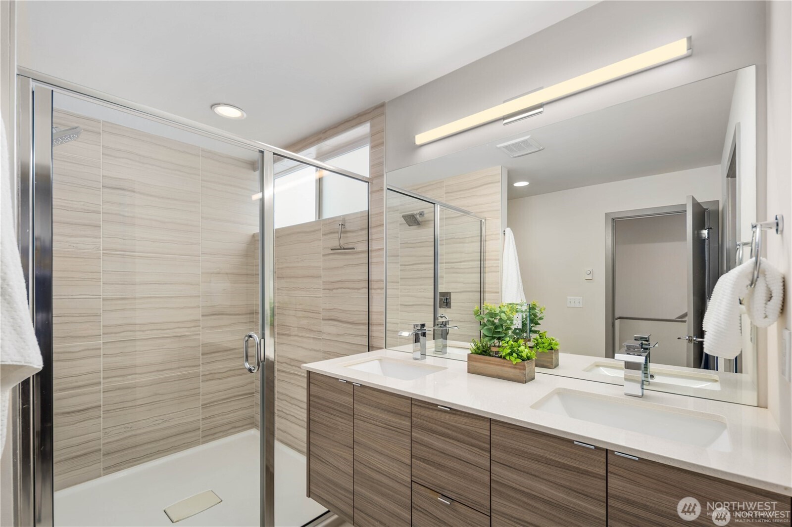 MASSIVE primary bathroom suite with walk-in shower, double vanity, storage closet and separate toilet area