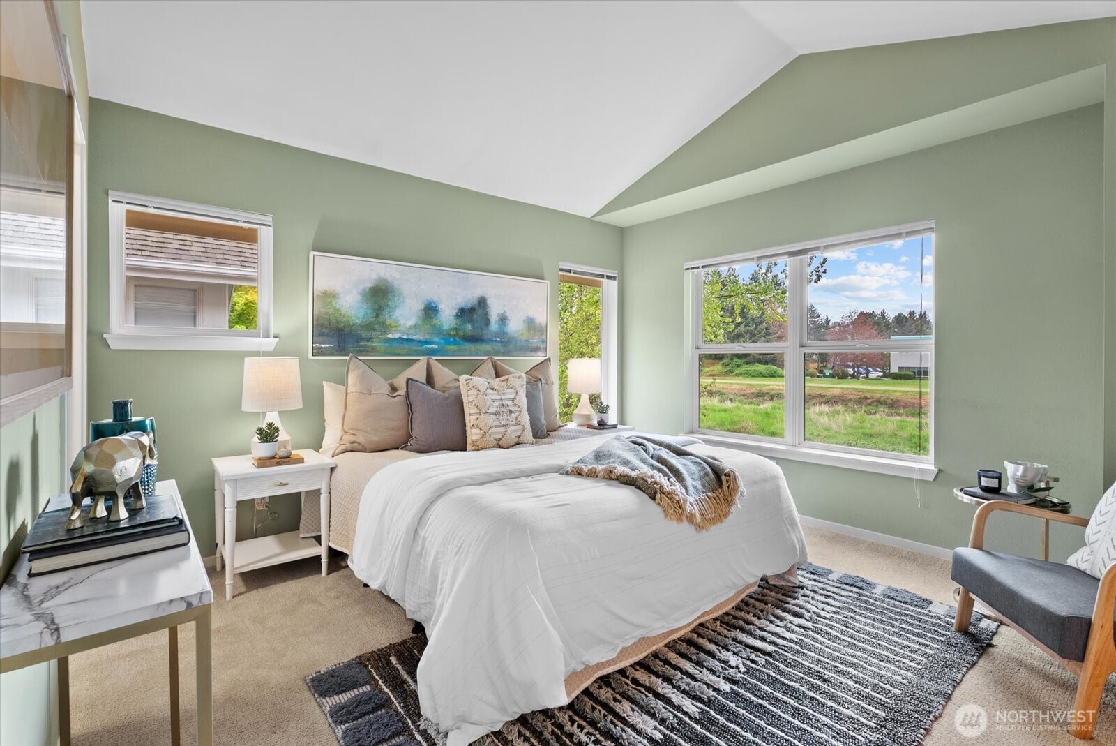 Upstairs you will find a primary bedroom with vaulted ceilings and more views of the Sammamish River Trail.