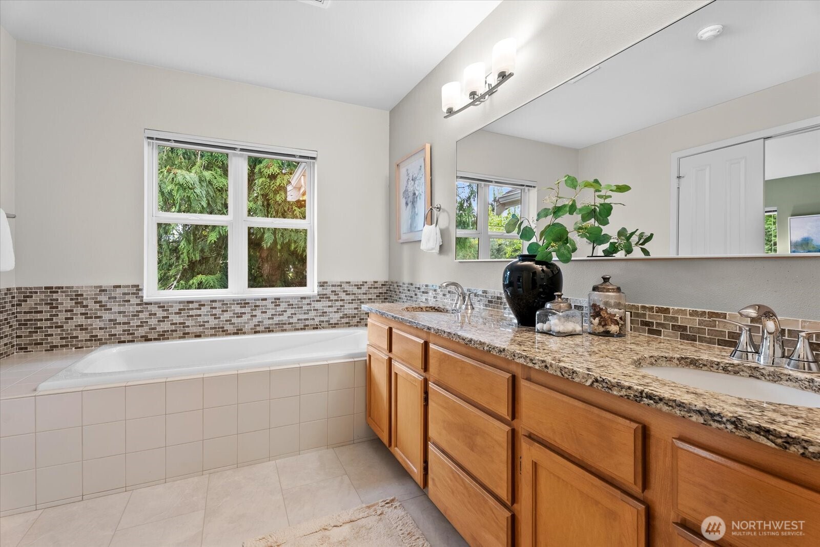 The primary suite has a large soaking tub, double vanity and a toilet room with standing shower.