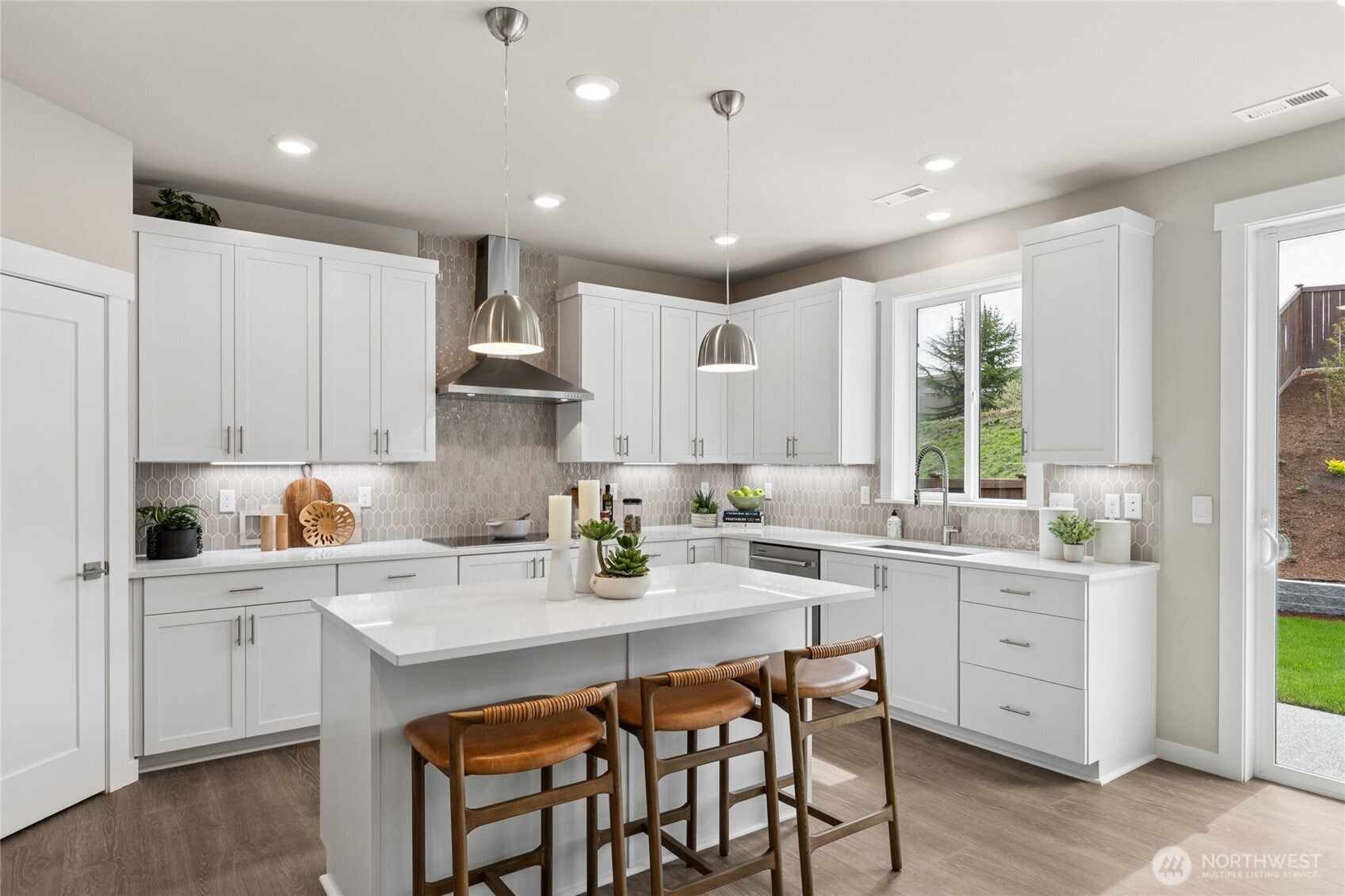 Modern kitchens with high end soft close cabinetry.  White cabinets throughout and modern slab quartz counters