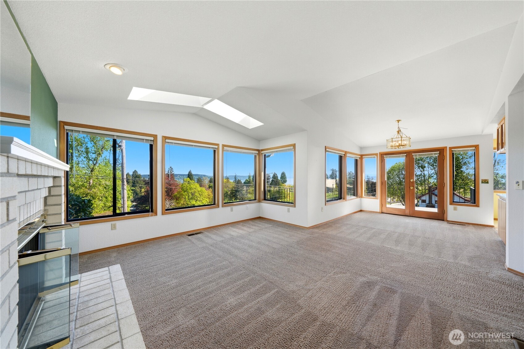 Living room and dining rooms without the virtual staging. You can see the door leading out to the view deck.
