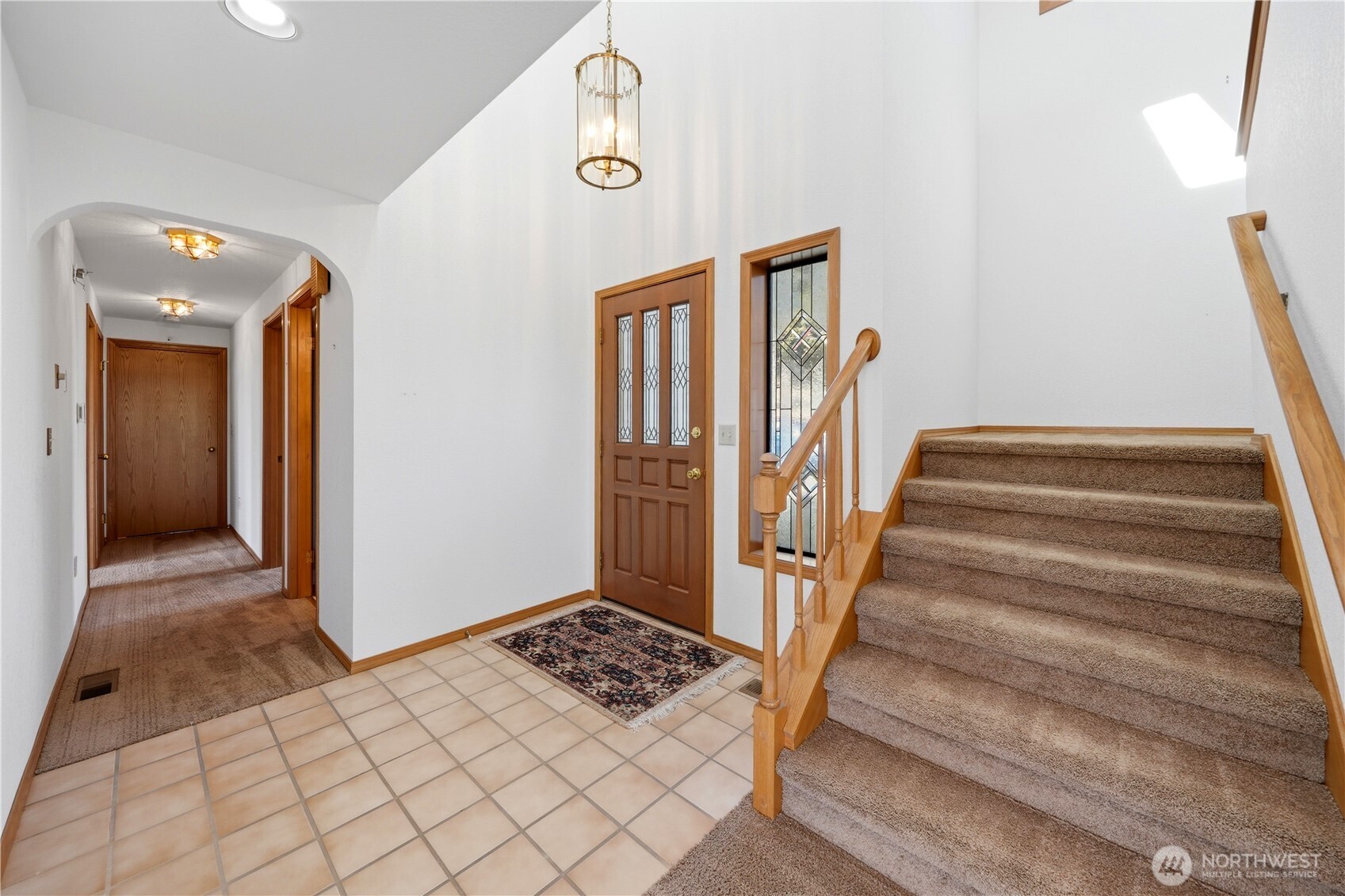 From the main entry, you look down the hallway. Through the end door is the laundry room and then the garage beyond that.
