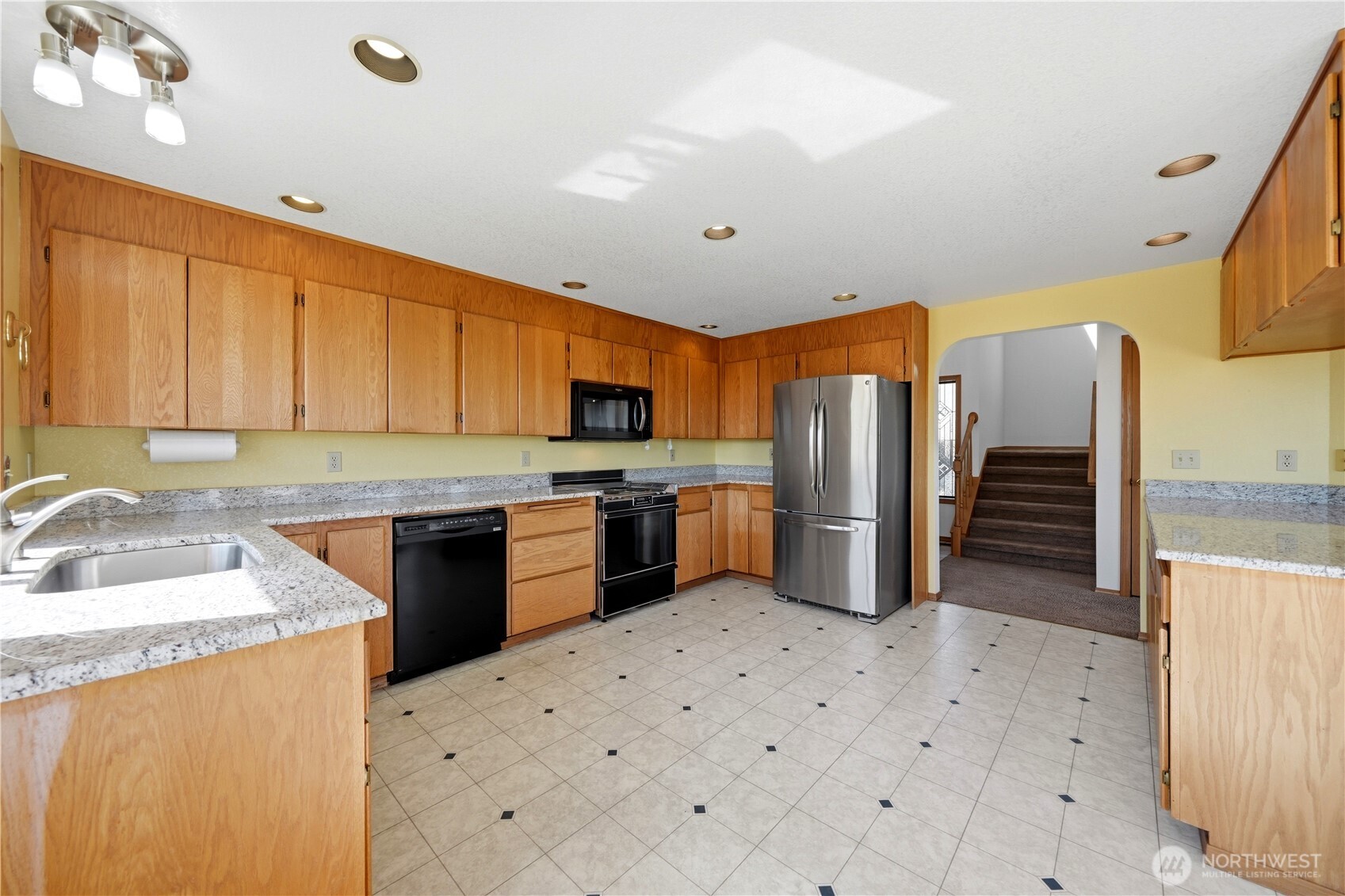 Updated kitchen with granite counters , looking back toward entry.