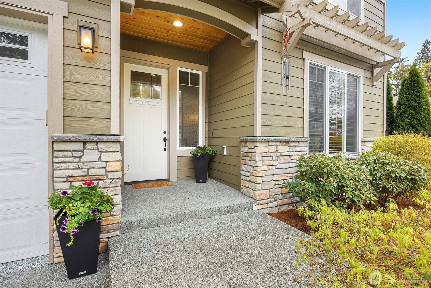 Welcoming entryway with beautiful landscaping.