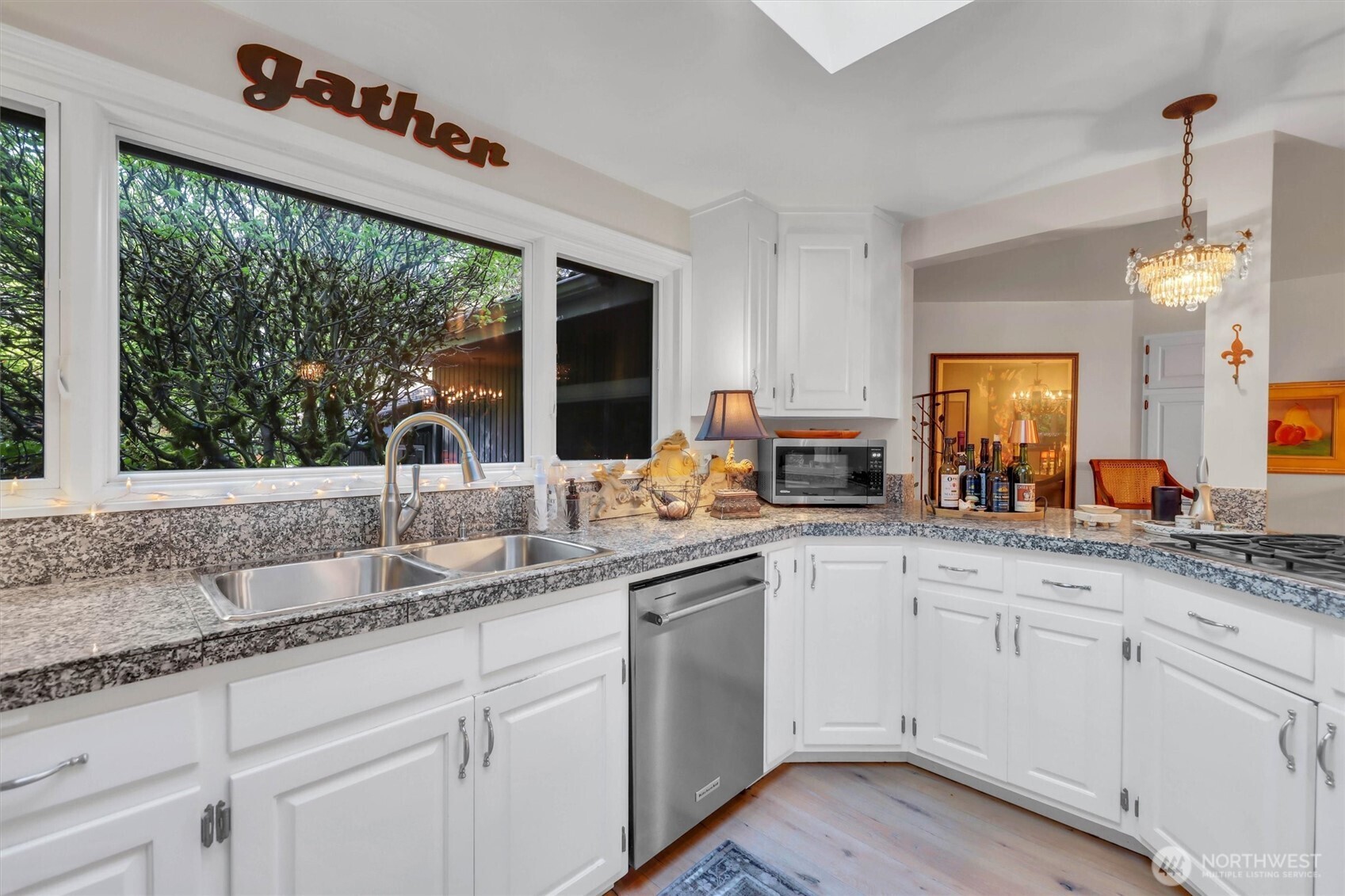 Triple window over the sink and granite counters.