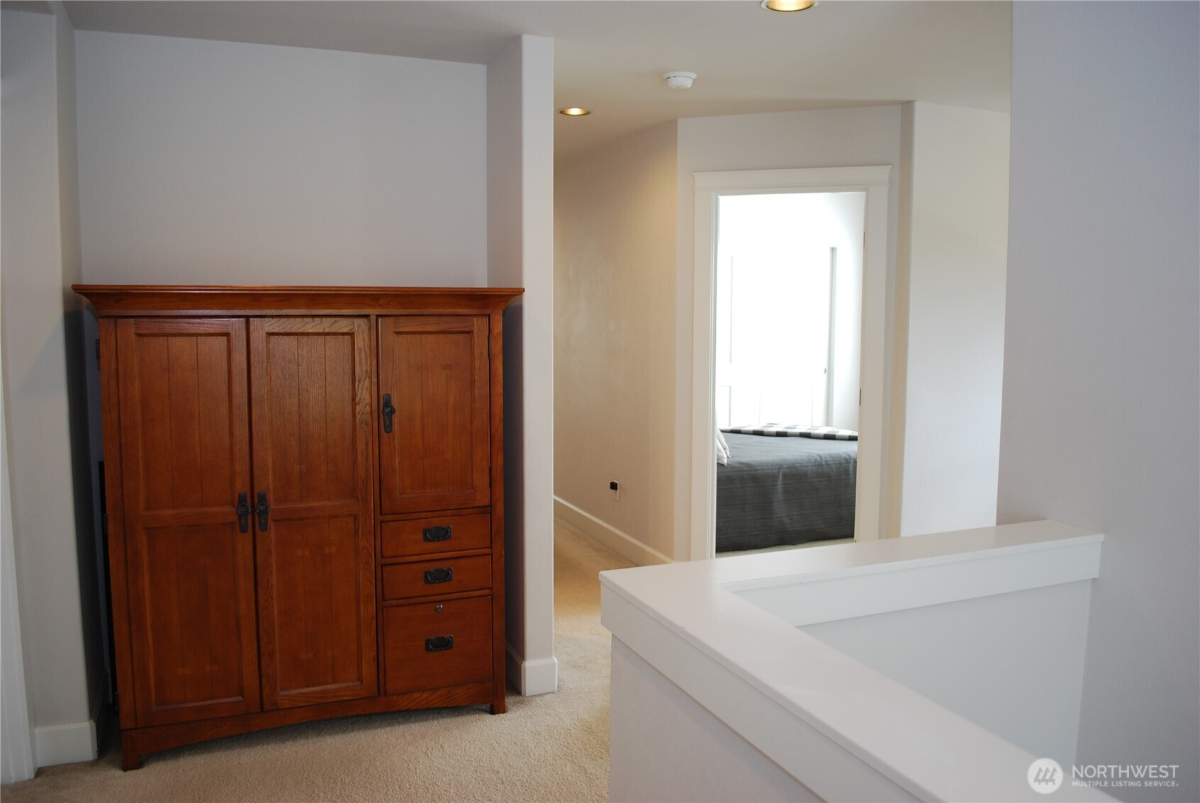Landing at the top of the stairs on the second floor.  Primary bedroom to the left, bedrooms, bathroom, and bonus (4th bedroom) to the right.