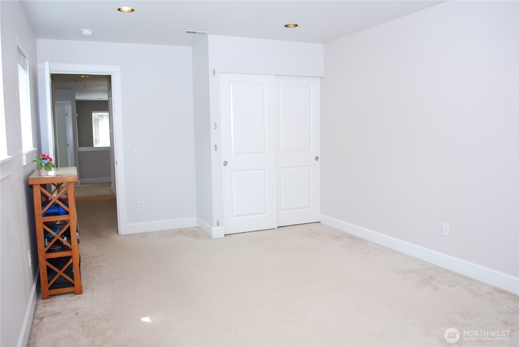 Looking across the bonus room back down the hall to the other bedrooms and bathroom.  Bonus room with a closet for a 4th bedroom or movie/hobby room.