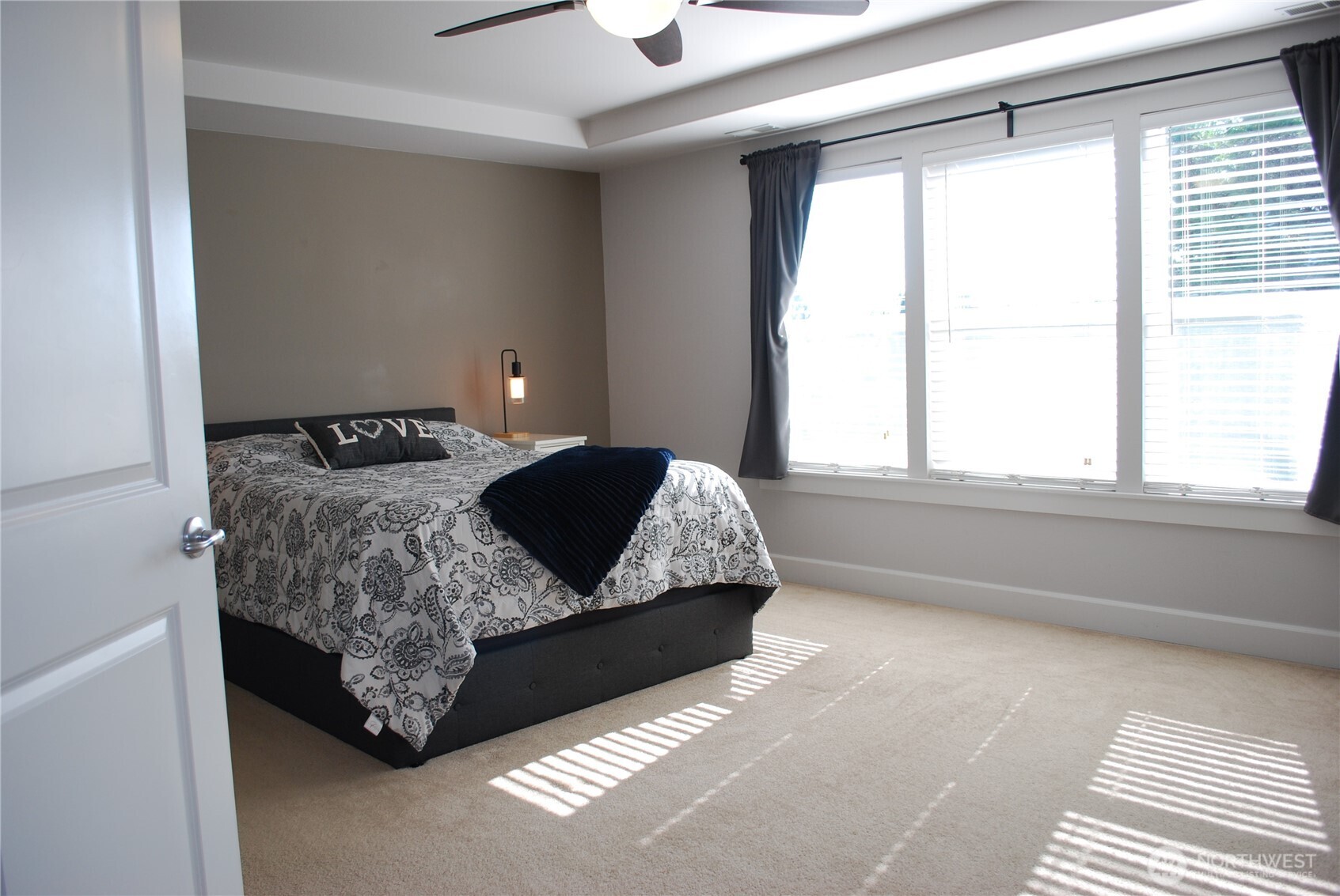At the top of the stairs, French doors open to the primary suite.