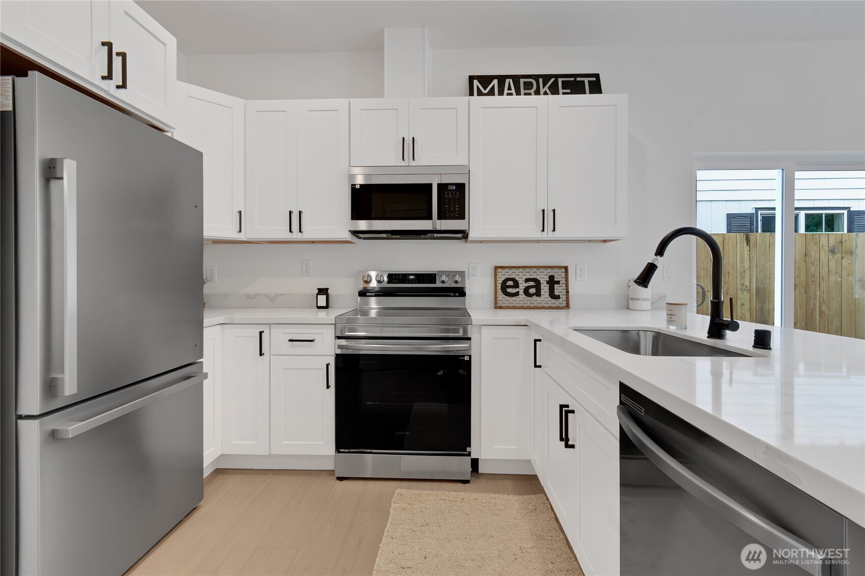 White Shaker Cabinets, Quartz Countertops and SS Appliances.