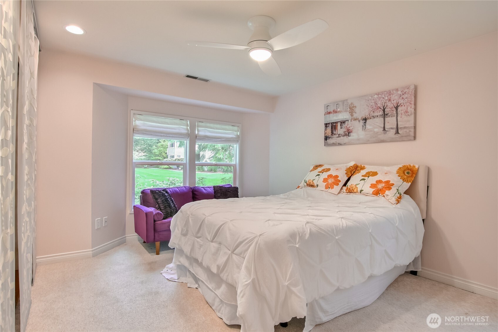 Primary suite with ceiling fan, lots of closet space, & views t  o greenery.