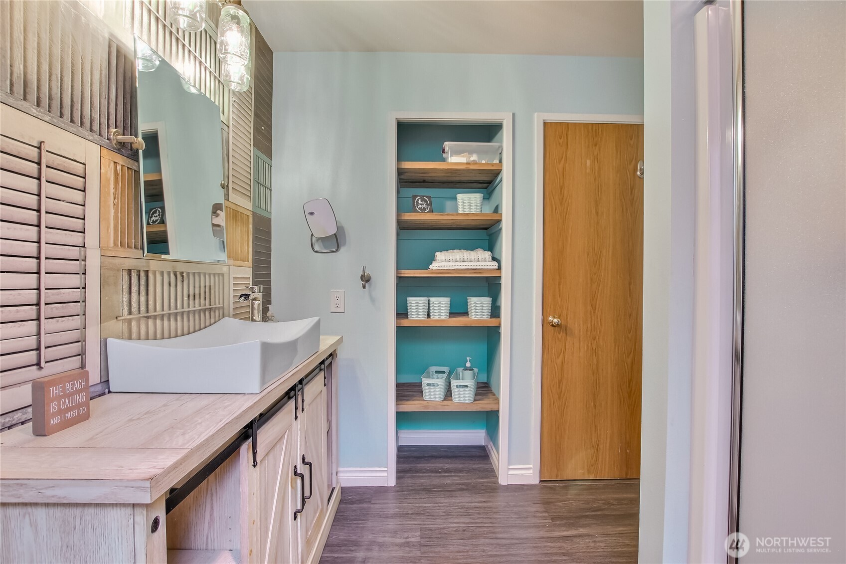 Walk-in laundry. Side-by-side washer/dryer with cabinets above.