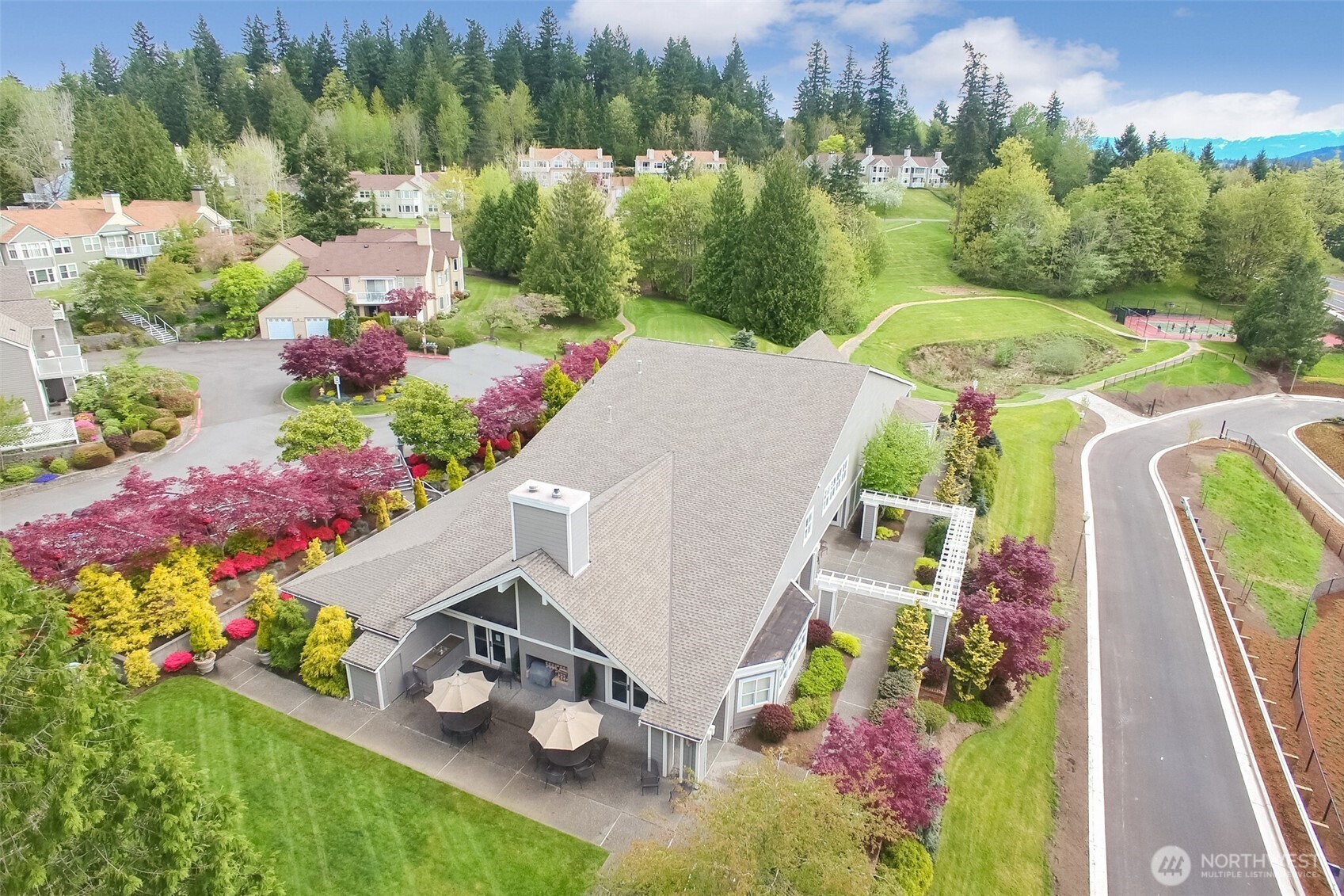 Community Clubhouse and patio. Pickleball court in distance.
