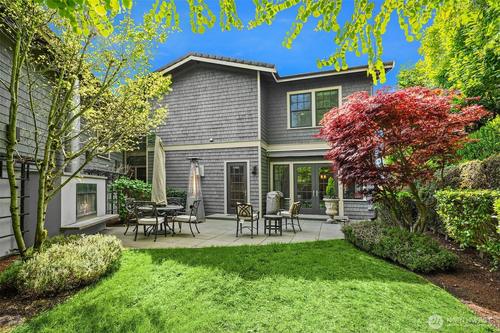 Private courtyard with outdoor fireplace connected to formal living and dining rooms.