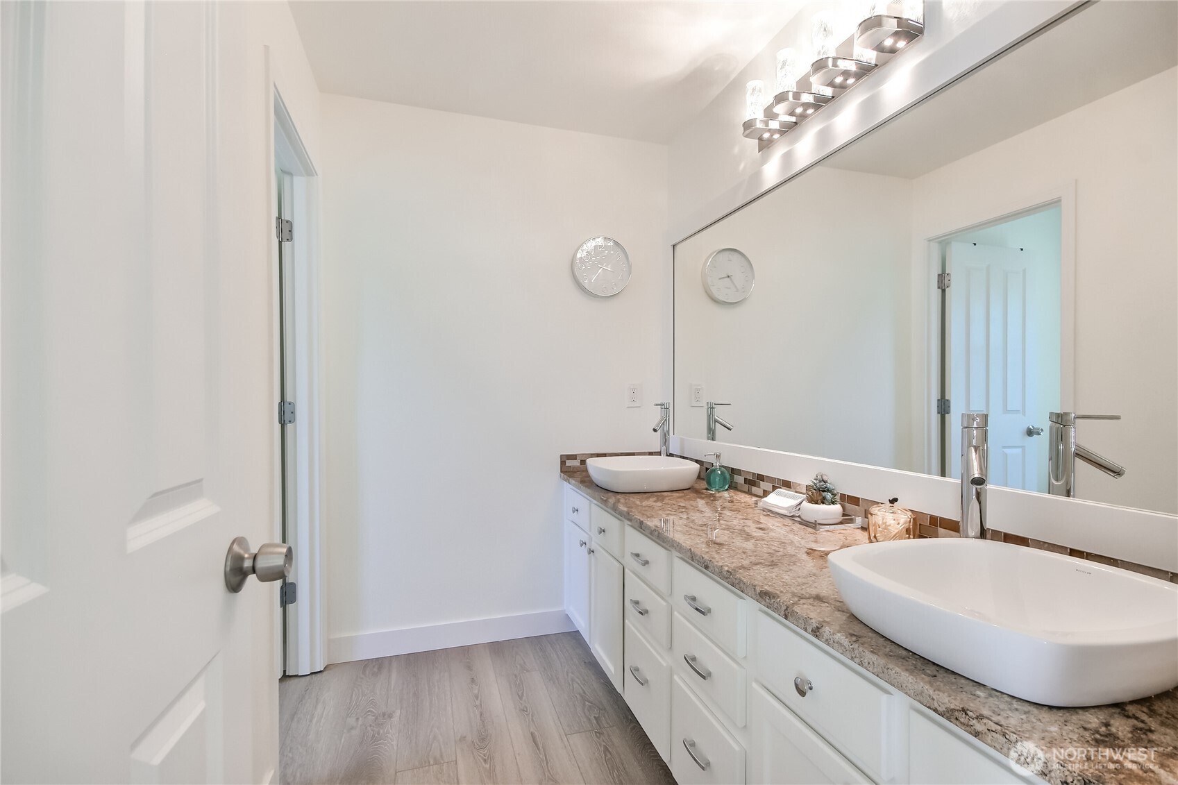Wonderful primary bathroom with double sink vanity, newer sinks, granite counters, faucets, lights, framed mirror & flooring. Toilet & shower are in separate, private space.
