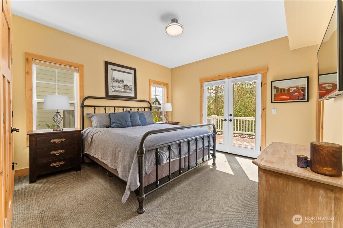 Upper level south facing Primary Bedroom with King sized bed and attached ensuite bathroom.