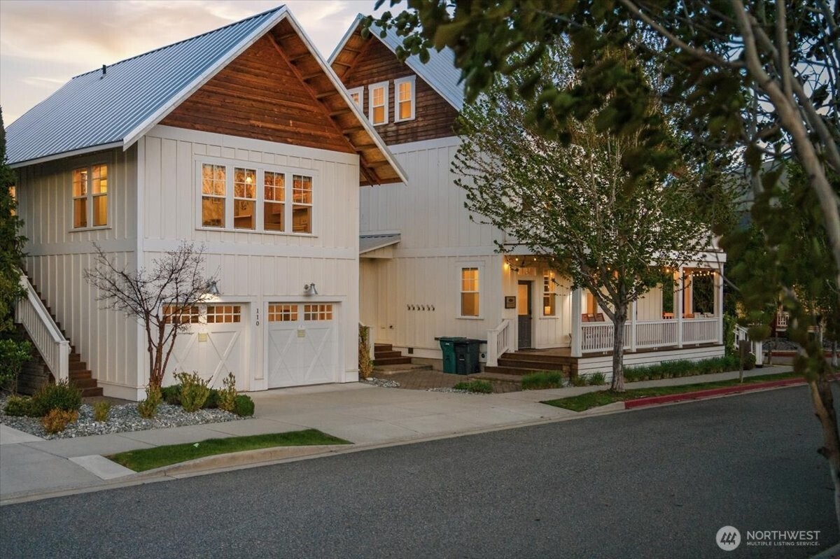 Exterior twilight view of main home and detached 2-car garage with 594sf 1bd/1bth and living room carriage house above.