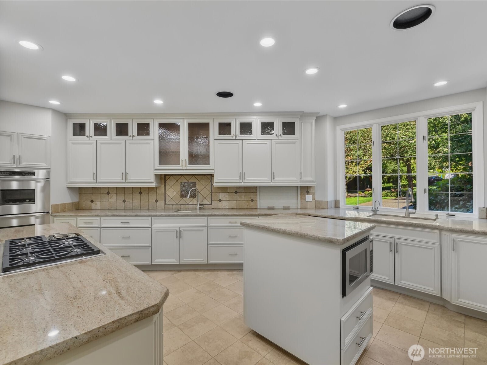 Bright and wonderful chef's kitchen.  Freshly painted cabinetry, new faucets, and designer finishes. Wolf stovetop and high end appliances.