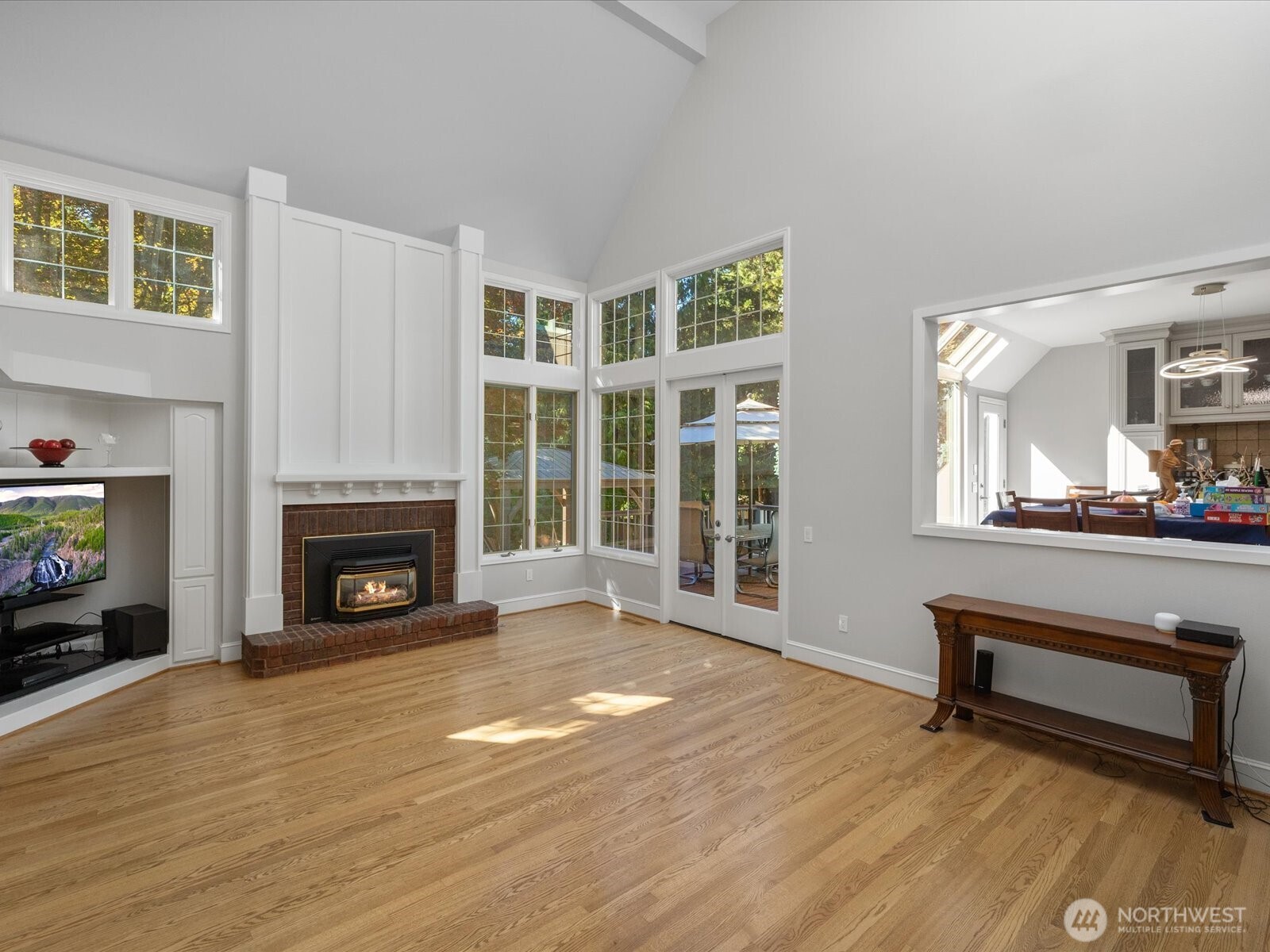 Family room off of the kitchen is sunken and has access to back deck / yard.  Gas fireplace.  HUGE vaulted ceilings with skylights.  Peek-a-boo view into the eating space / sun room.