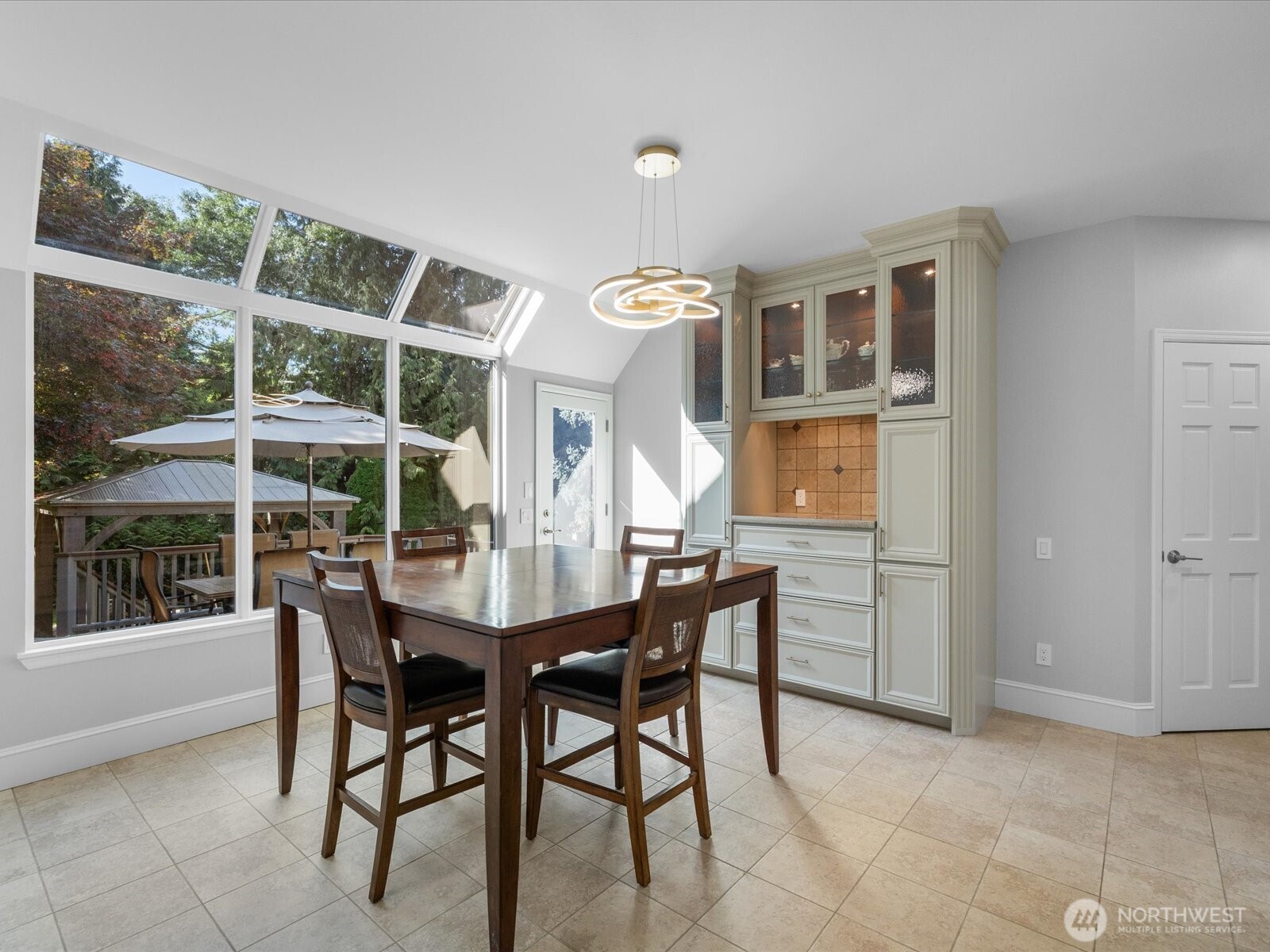 Off kitchenneating space with access to back deck and yard.  New lighting.  Freshly painted.  Lots of storage.  aka:  sun room.  These south facing windows are new and updated with UV protection.