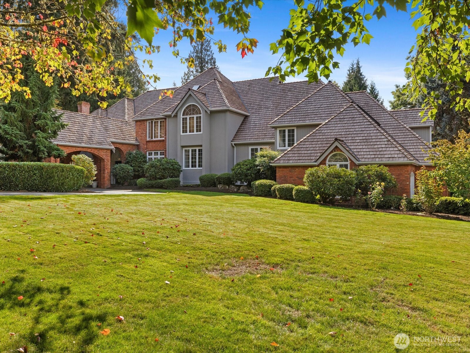 Circular driveway with covered entrance and stunning curb appeal.