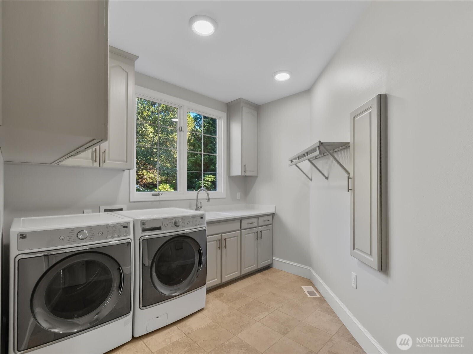 Laundry Room has been freshly painted with new countertops, sink, and faucet.