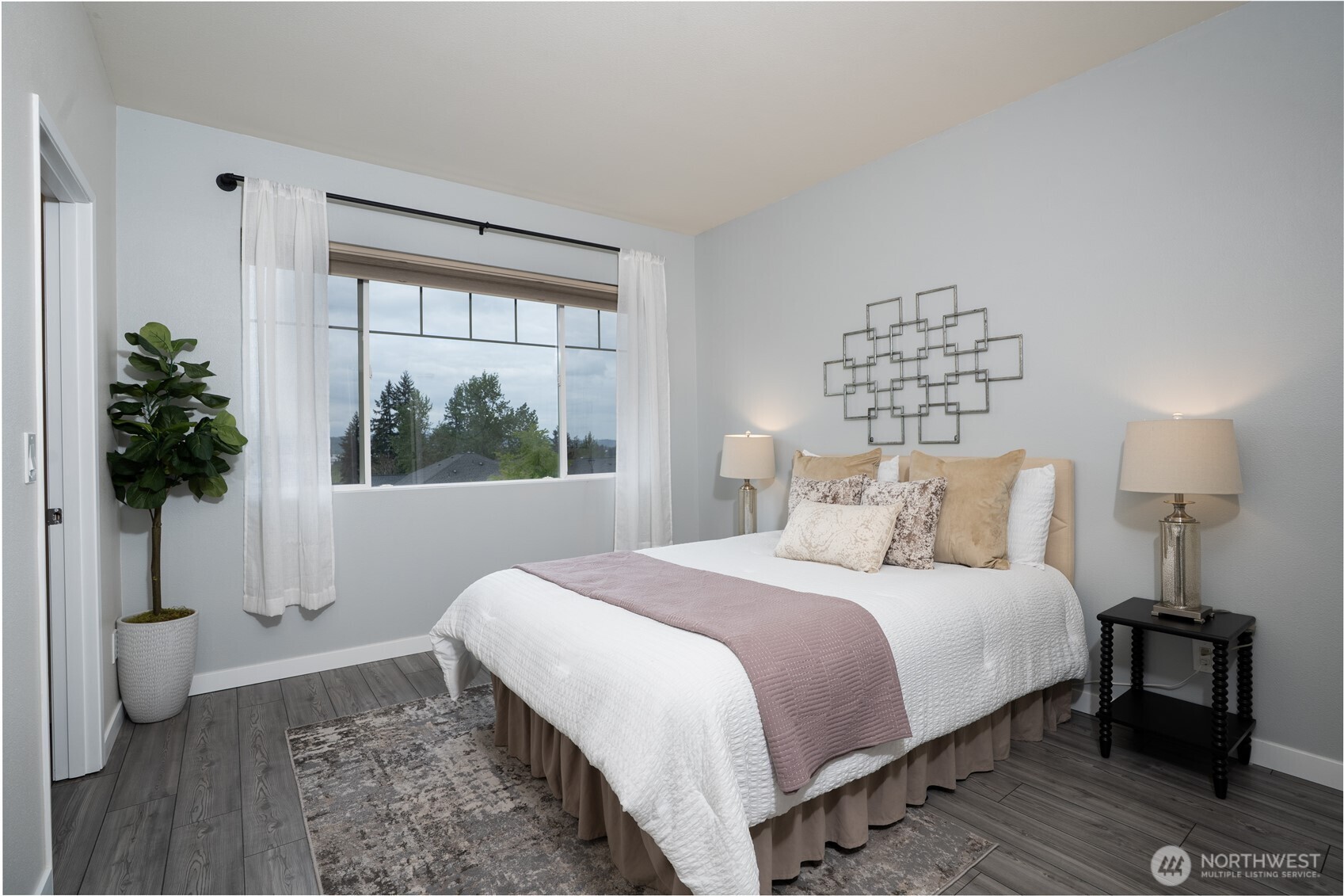 The primary bedroom offers a comfortable retreat with ample space, natural light, and a peaceful atmosphere for rest and relaxation.