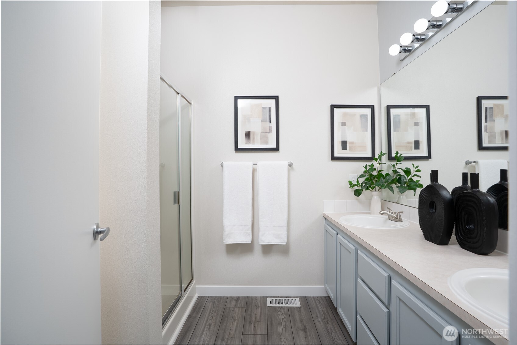 The primary bathroom includes a walk-in shower, offering a clean, modern, and convenient space to start and end your day.