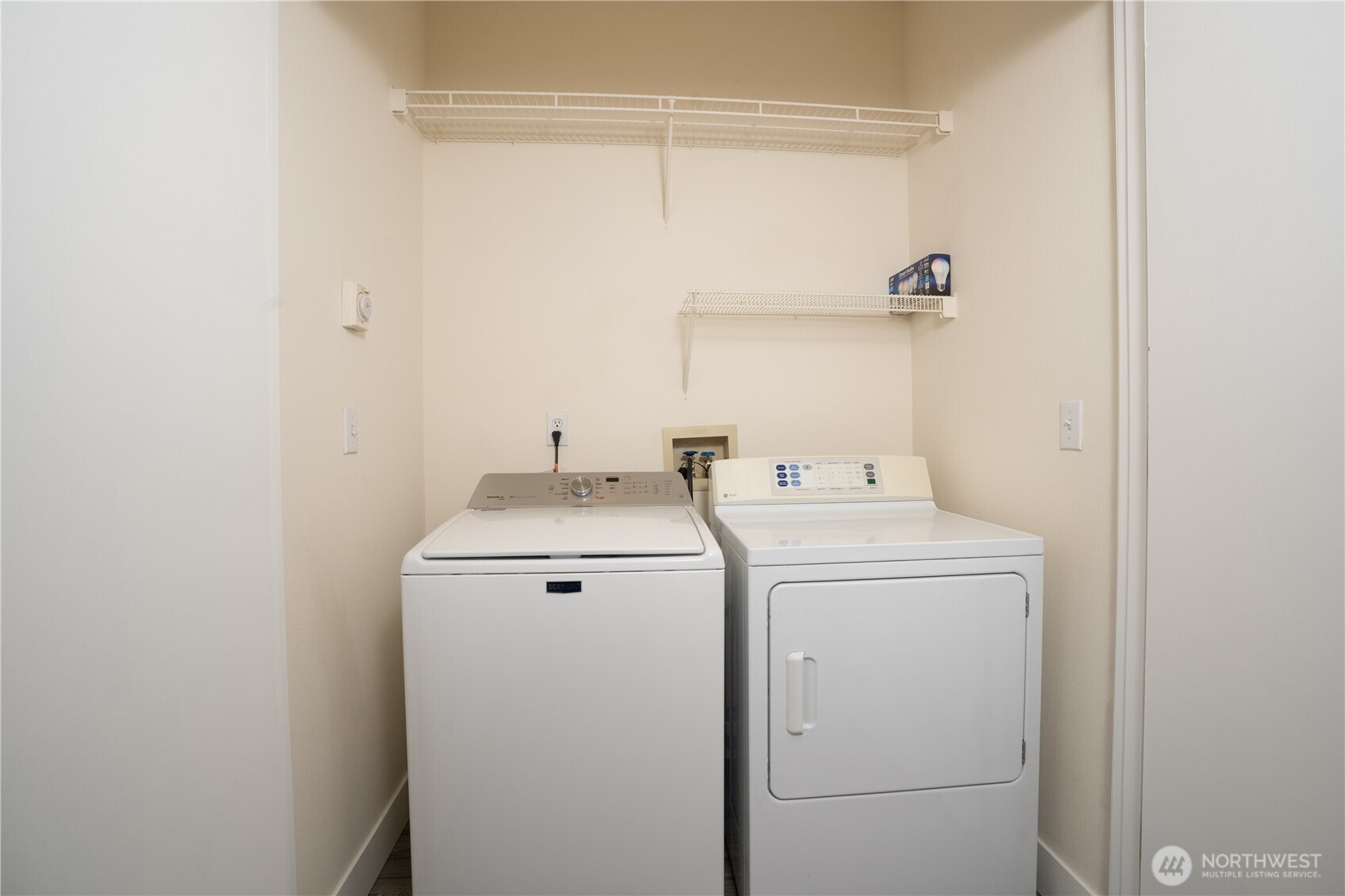Laundry area located upstairs between both bedrooms.