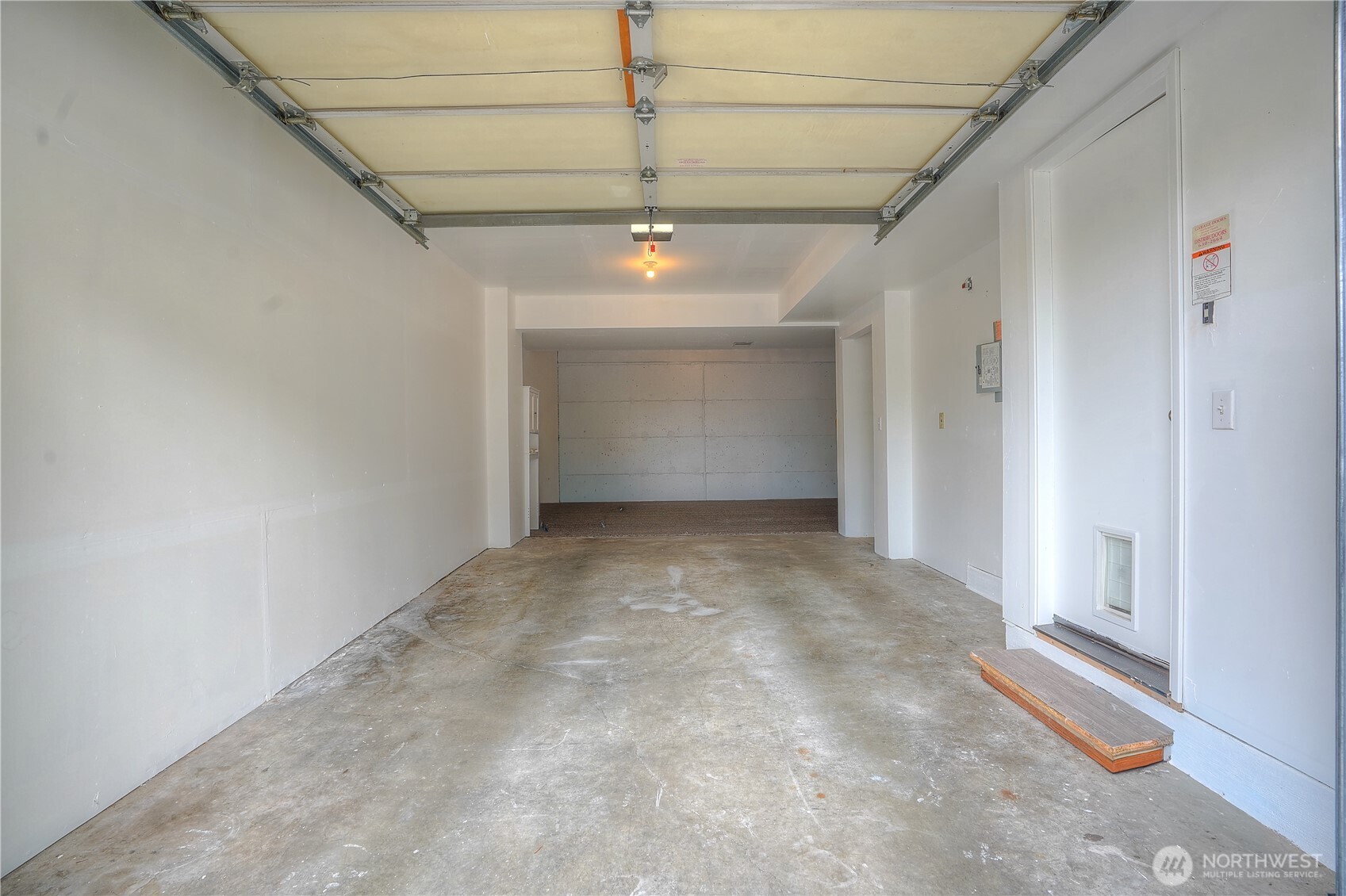 Oversized tandem garage offers flexible space for parking, storage or a home gym.