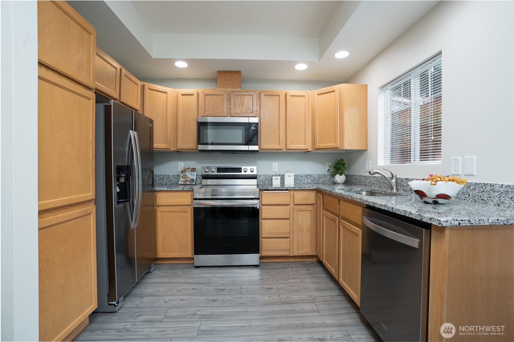 The kitchen is equipped with all stainless steel appliances, offering a sleek, modern look and everyday functionality.